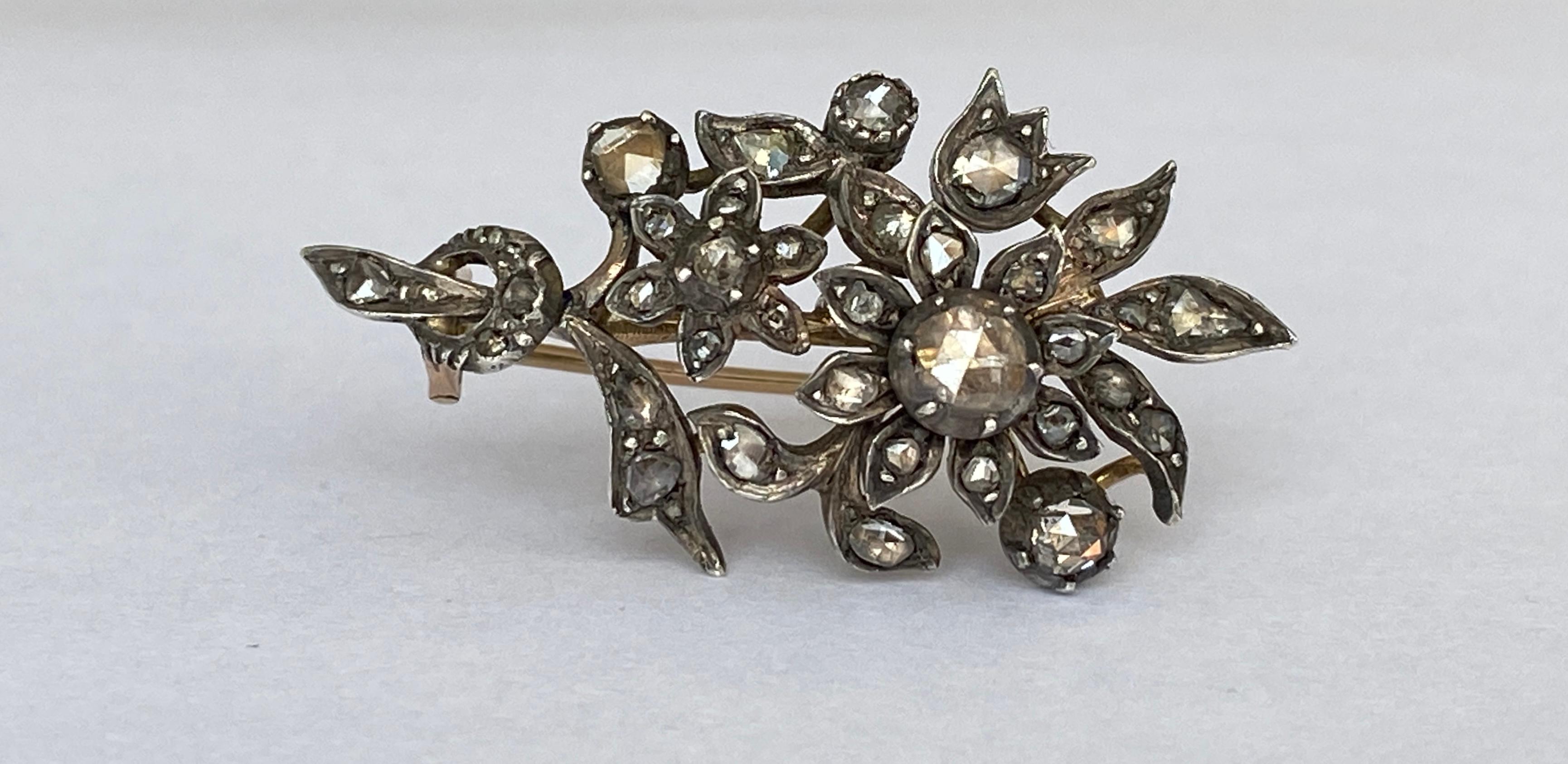 This beautiful antique brooch is made of 14 carat yellow gold and silver. The brooch is set with rose-cut diamonds. The brooch is set with a rose cut diamond of approximately 0.25 ct (a modern brilliant cut diamond of this size would have an