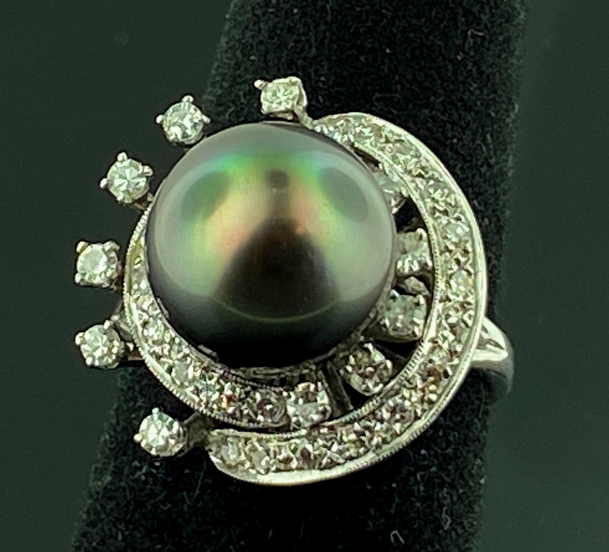 Set in 14 karat white gold is an 11.5 millimeter Tahitian Pearl surrounded with 24 round brilliant cut diamonds with a total diamond weight of 0.75 carats.  Color is H, Clarity is VS.  Ring size is 7.