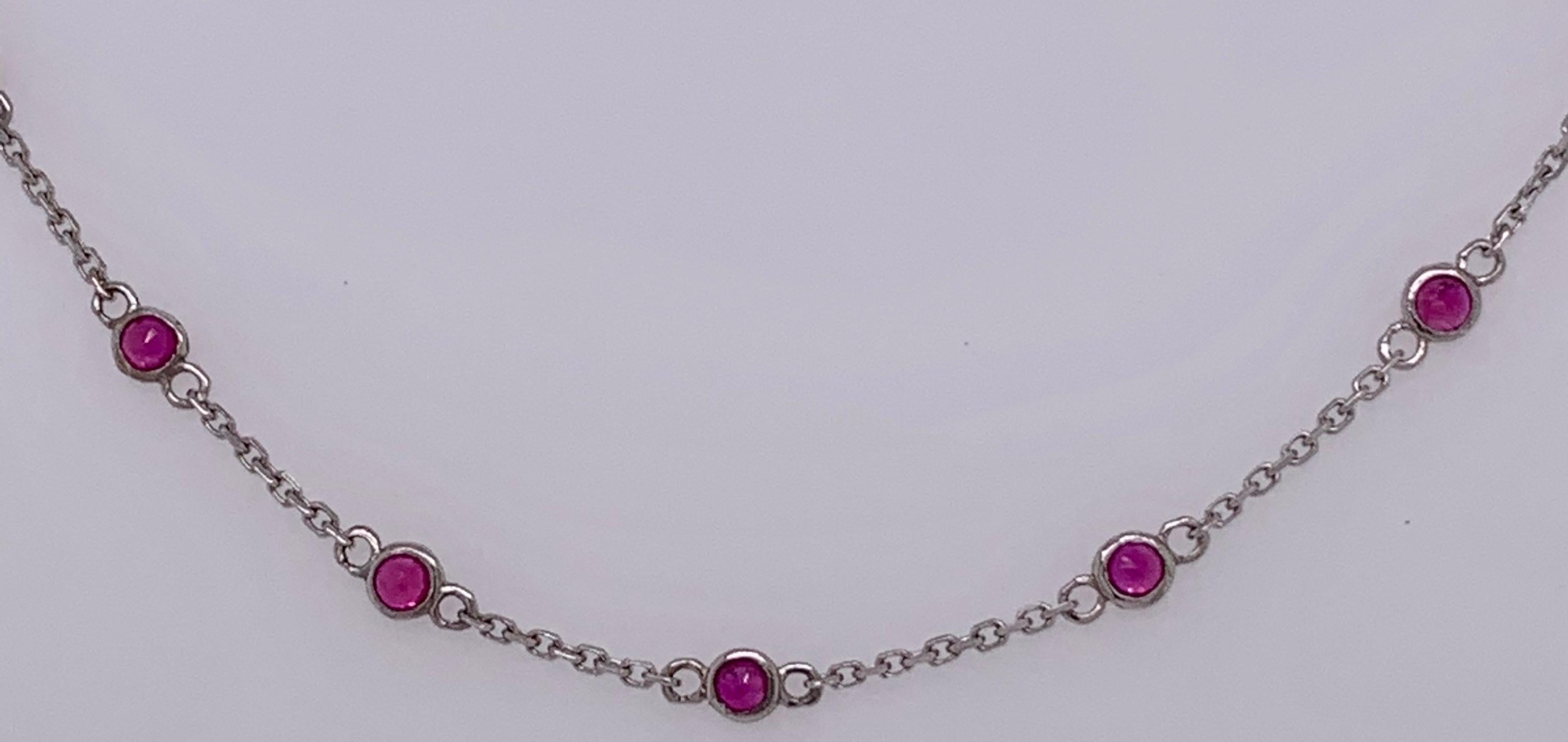 14 Karat White Gold 18 Inch Oval Link Station Necklace with Garnet Stones.
2.57 grams total weight.