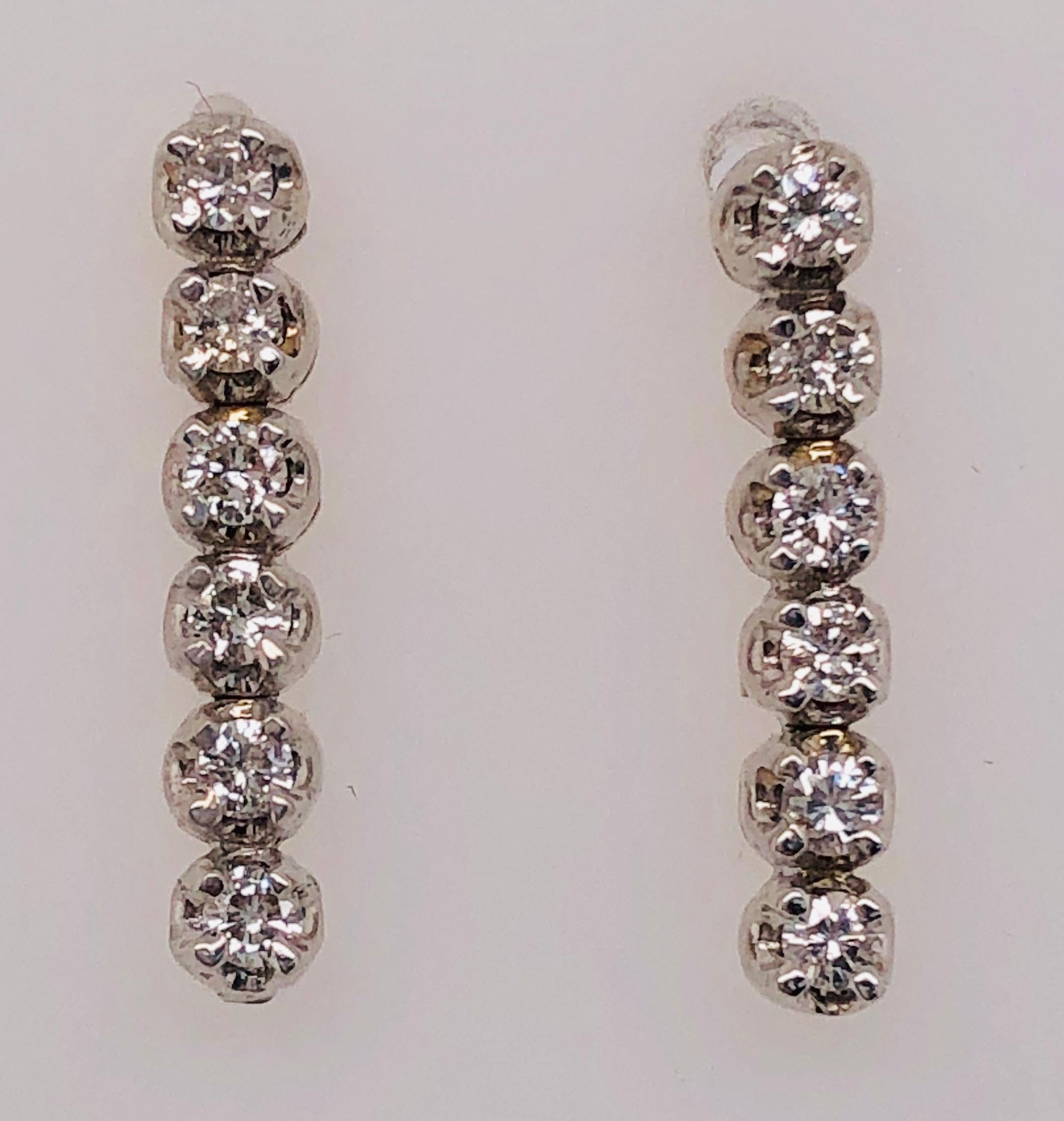 14 Kt White Gold And Diamond Freestyle Drop Earrings 
0.75 Total Diamond Weight
3.18 grams Total Weight.

