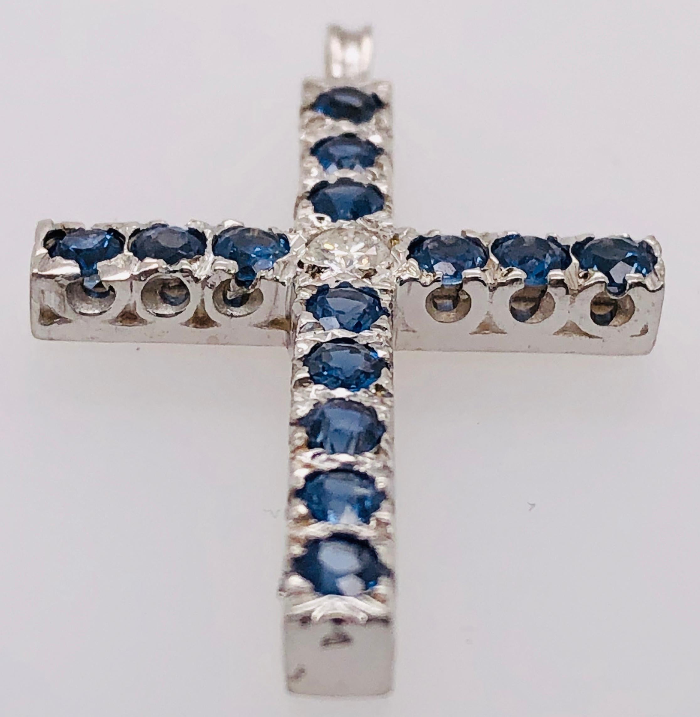 14 Kt White Gold Diamond And Blue Sapphire Cross Pendant 
3.5 grams Total Weight.