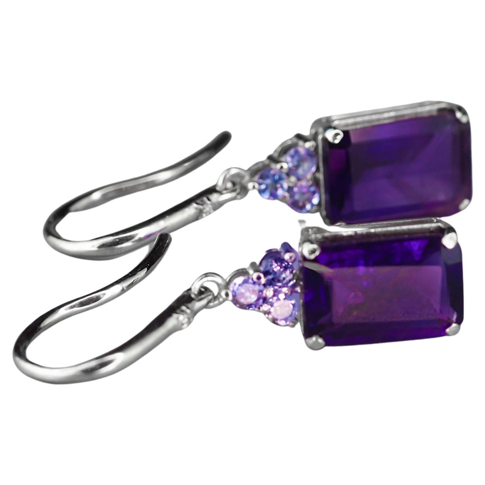 14 kt white solid gold earrings with central  natural amethysts, tanzanites and diamonds. Febrary birthstone.
Weight: 5.3 g.
Size: 33 x 8.5 mm.

Central sotnes: Natural amethysts, color - violet.
Weight: approx 6.00 ct in total, emerald