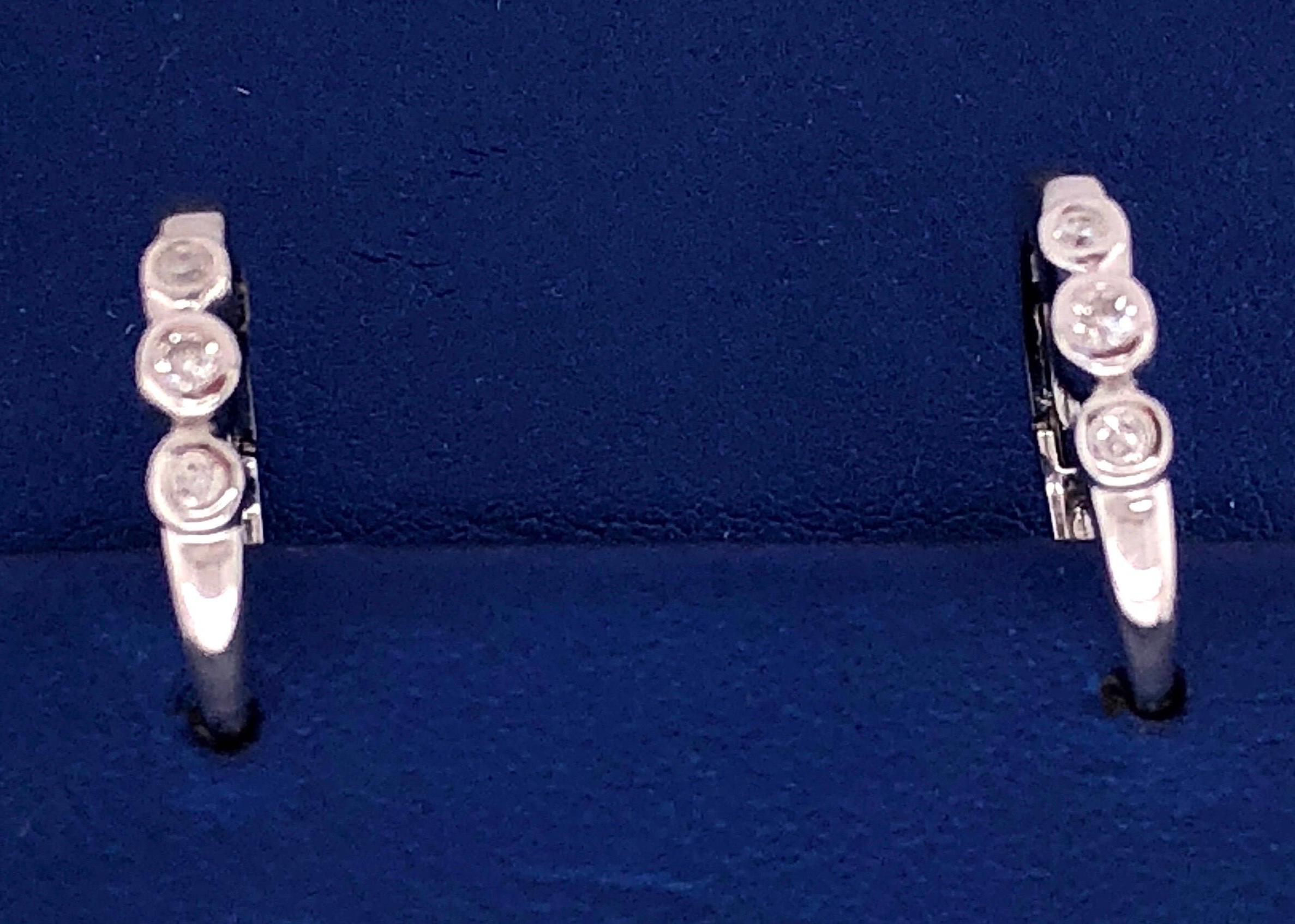 14 Kt White Gold Three Diamond Hoop Earrings
3 grams total weight.
