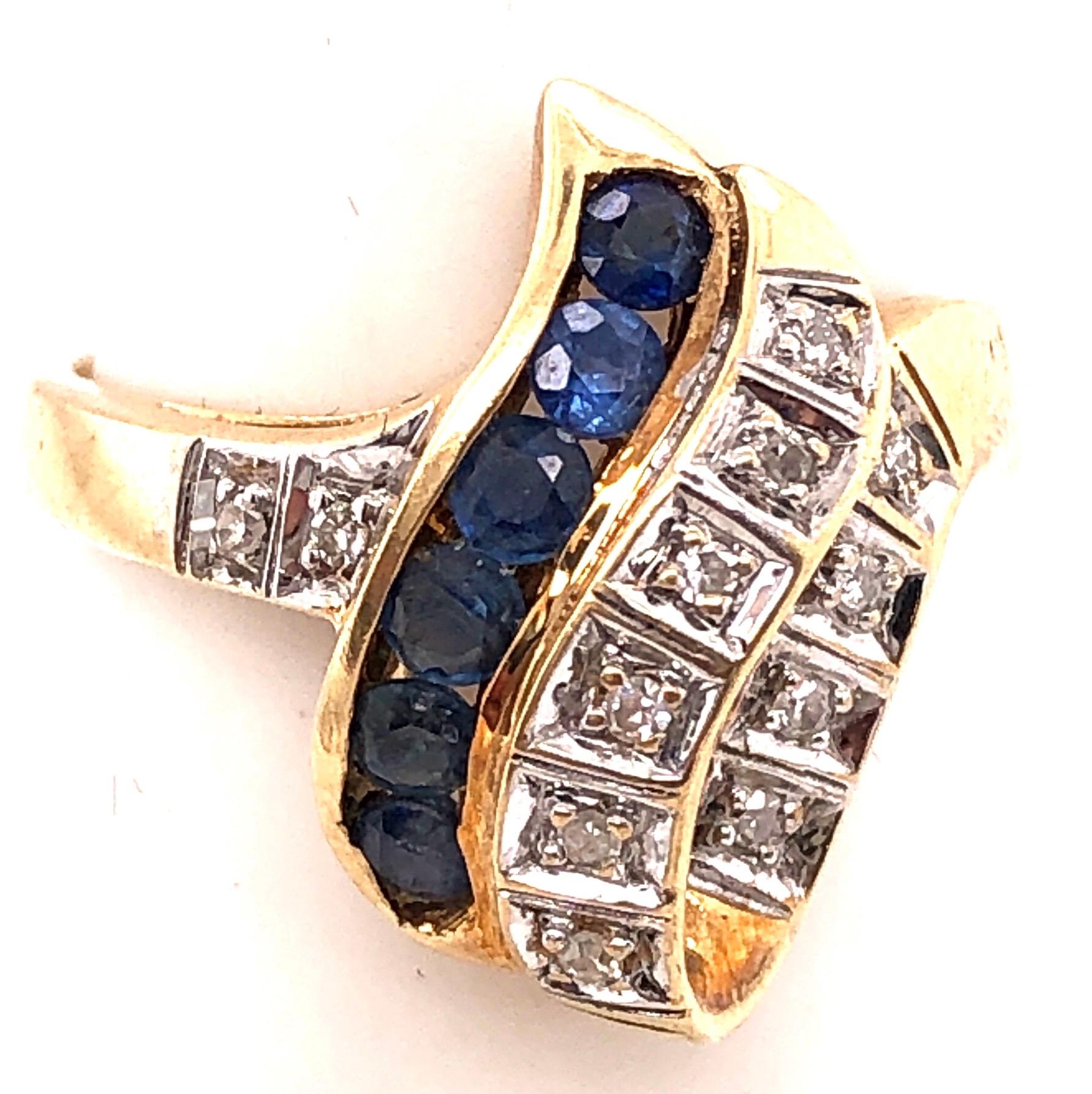 14 Karat Yellow And White Gold Blue Sapphire and Diamond Contemporary Ring 
Size 6.5 
3.80 grams total weight.