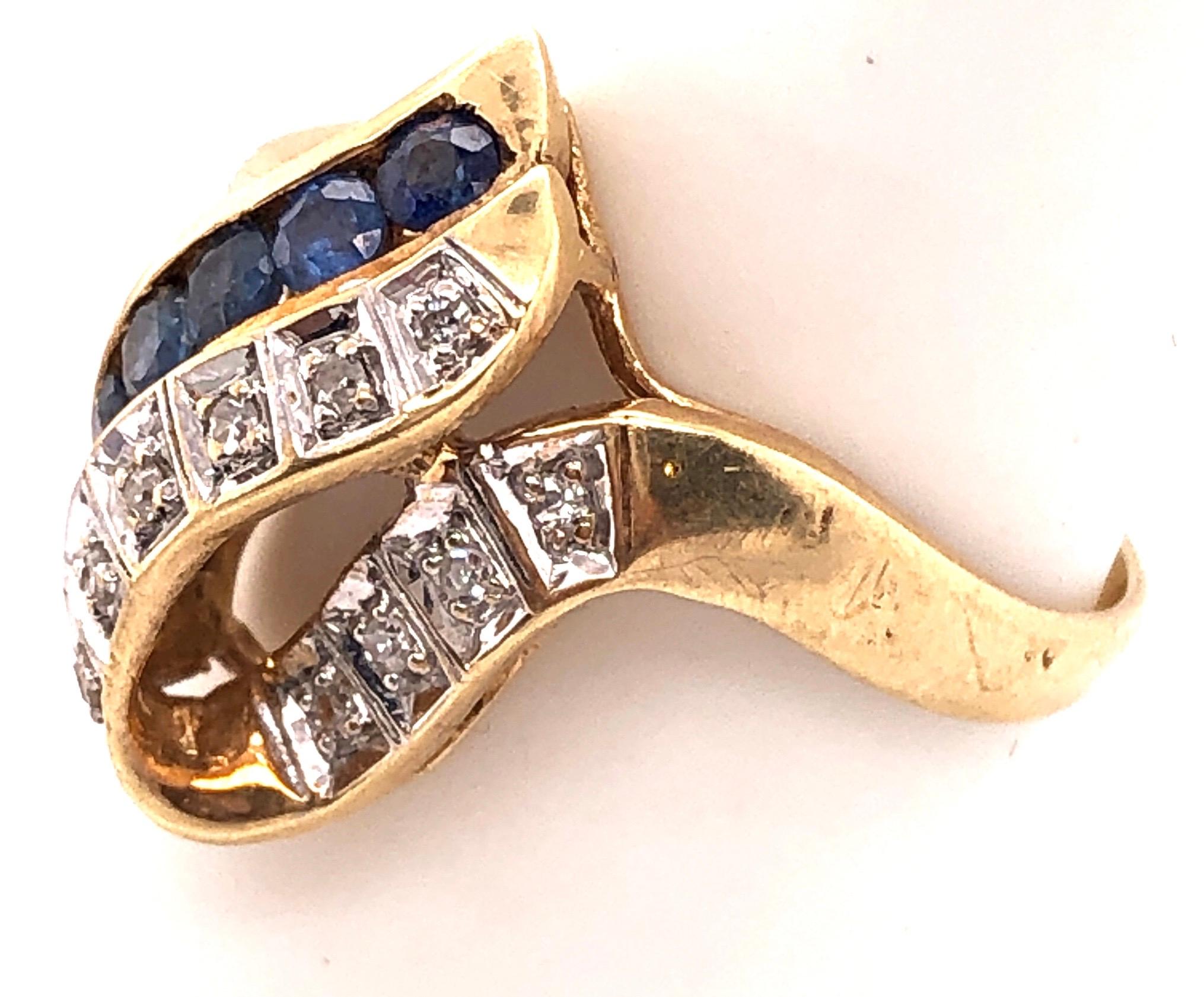 Modern 14 Karat Yellow and White Gold Blue Sapphire and Diamond Contemporary Ring For Sale