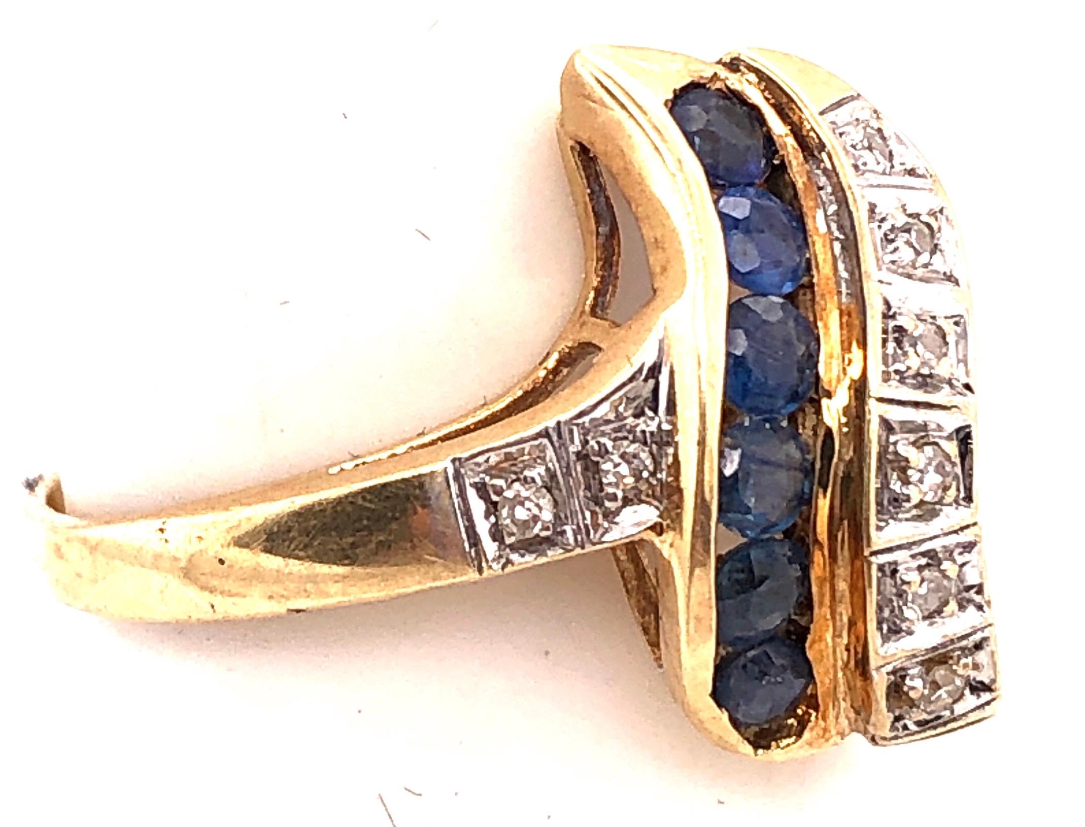 Round Cut 14 Karat Yellow and White Gold Blue Sapphire and Diamond Contemporary Ring For Sale