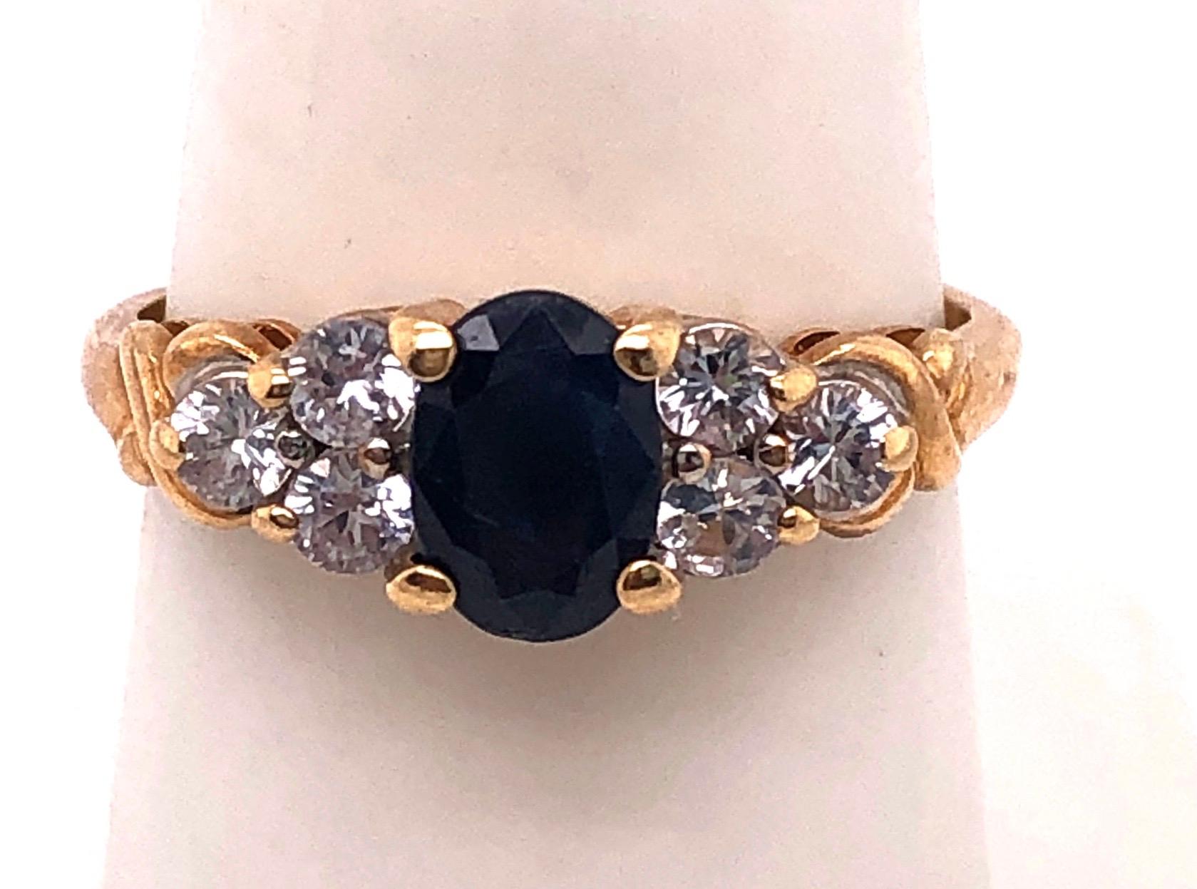 Modern 14 Karat Gold Fashion Ring Center Oval Sapphire and Diamond Accent 0.50 TDW For Sale