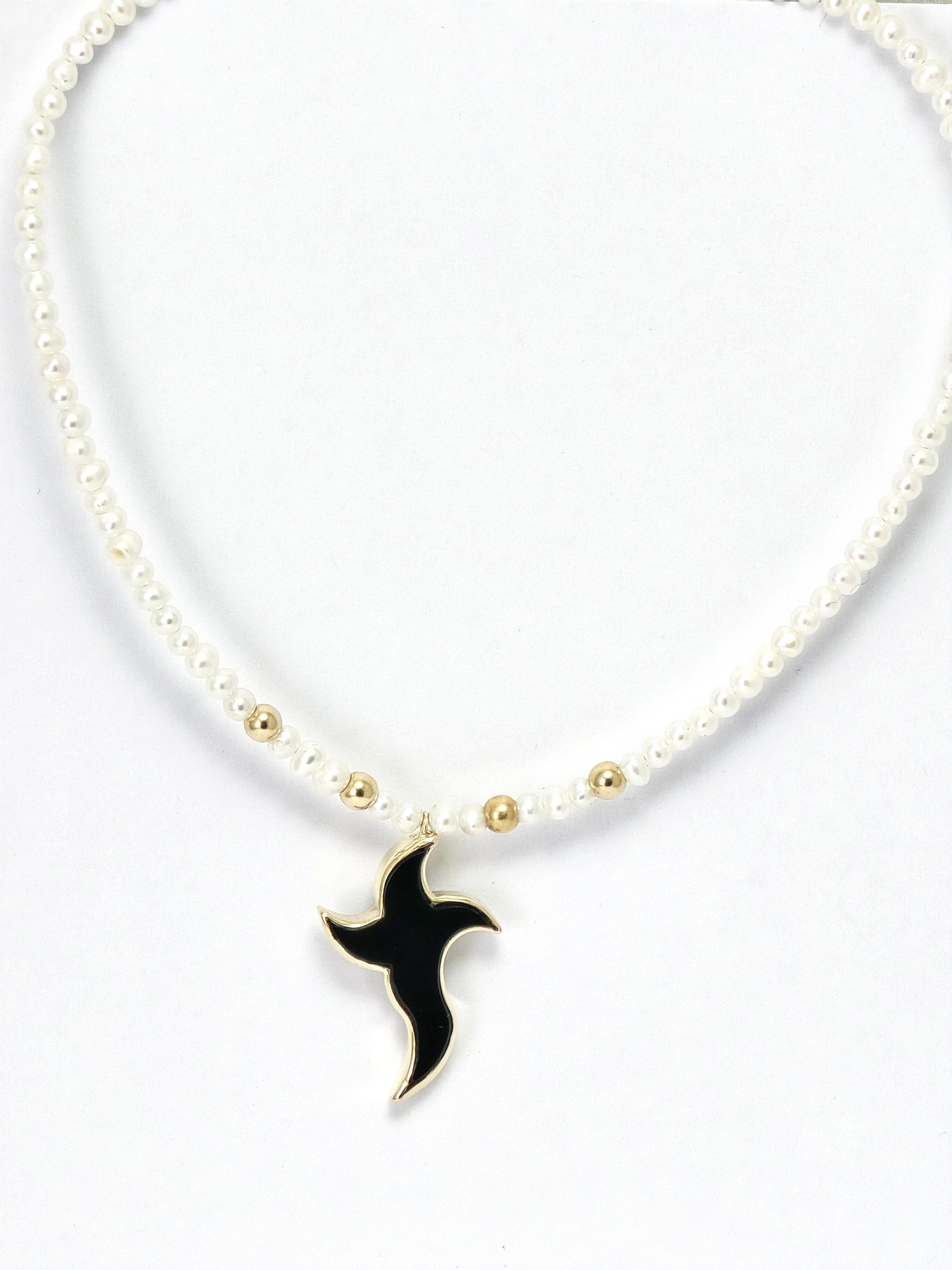 This elegant necklace from Antonio Gems brings together classic materials with modern, artistic design. Hand-crafted in 14 kt yellow gold, the piece features a striking black onyx cross, polished to a smooth, glossy finish and framed in warm gold.