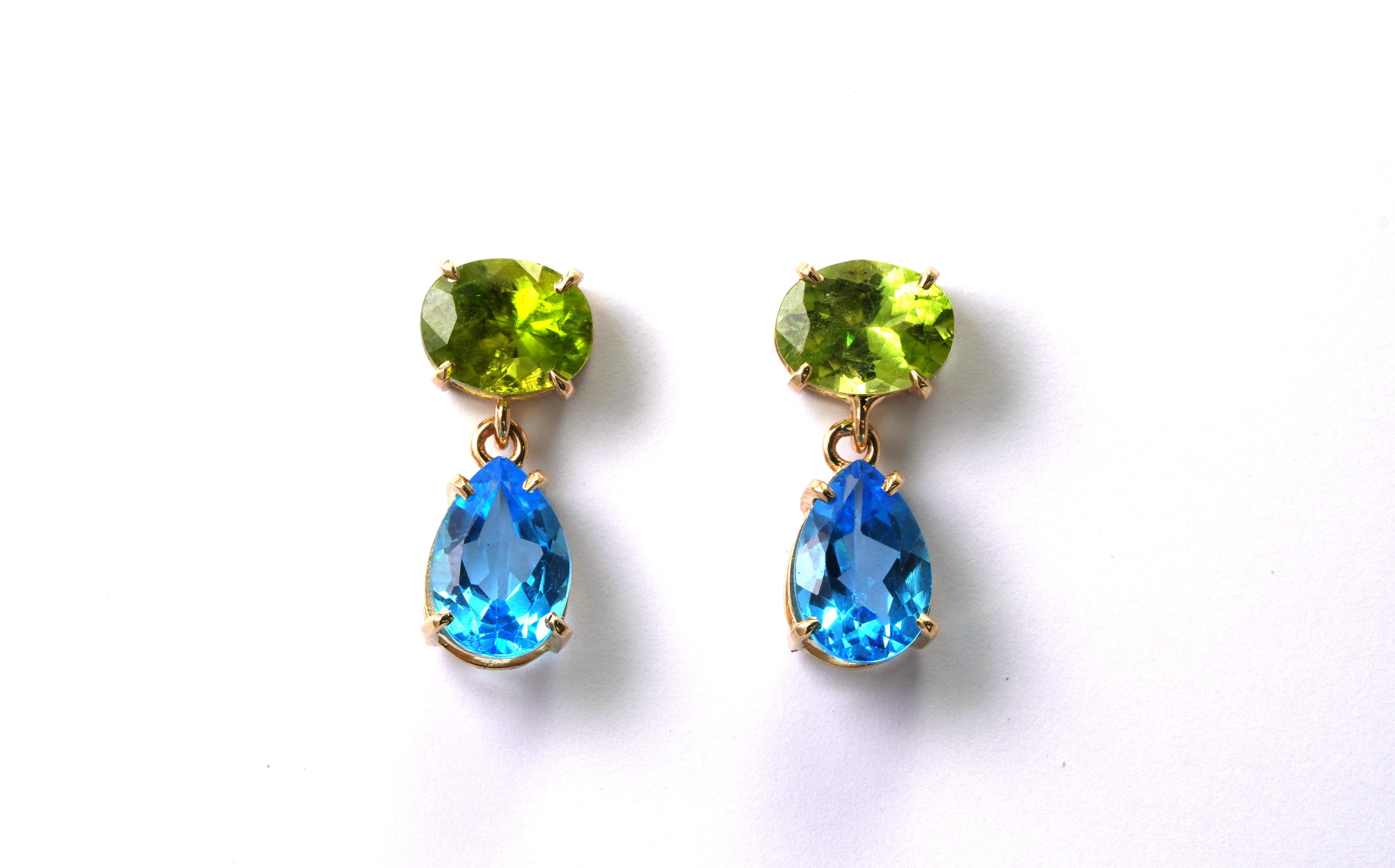 14 kt Gold pair of earrings with Peridot and Blue Topaz
Gold color: Yellow
Dimensions: 25 mm height
Total weight: 6.77 grams

Set with:
- Peridot
Cut: Oval
Color: Green
Weight: 6.25 Carat

- Blue Topaz
Cut: Pear
Color: Blue
Weight: 7.43 Carat