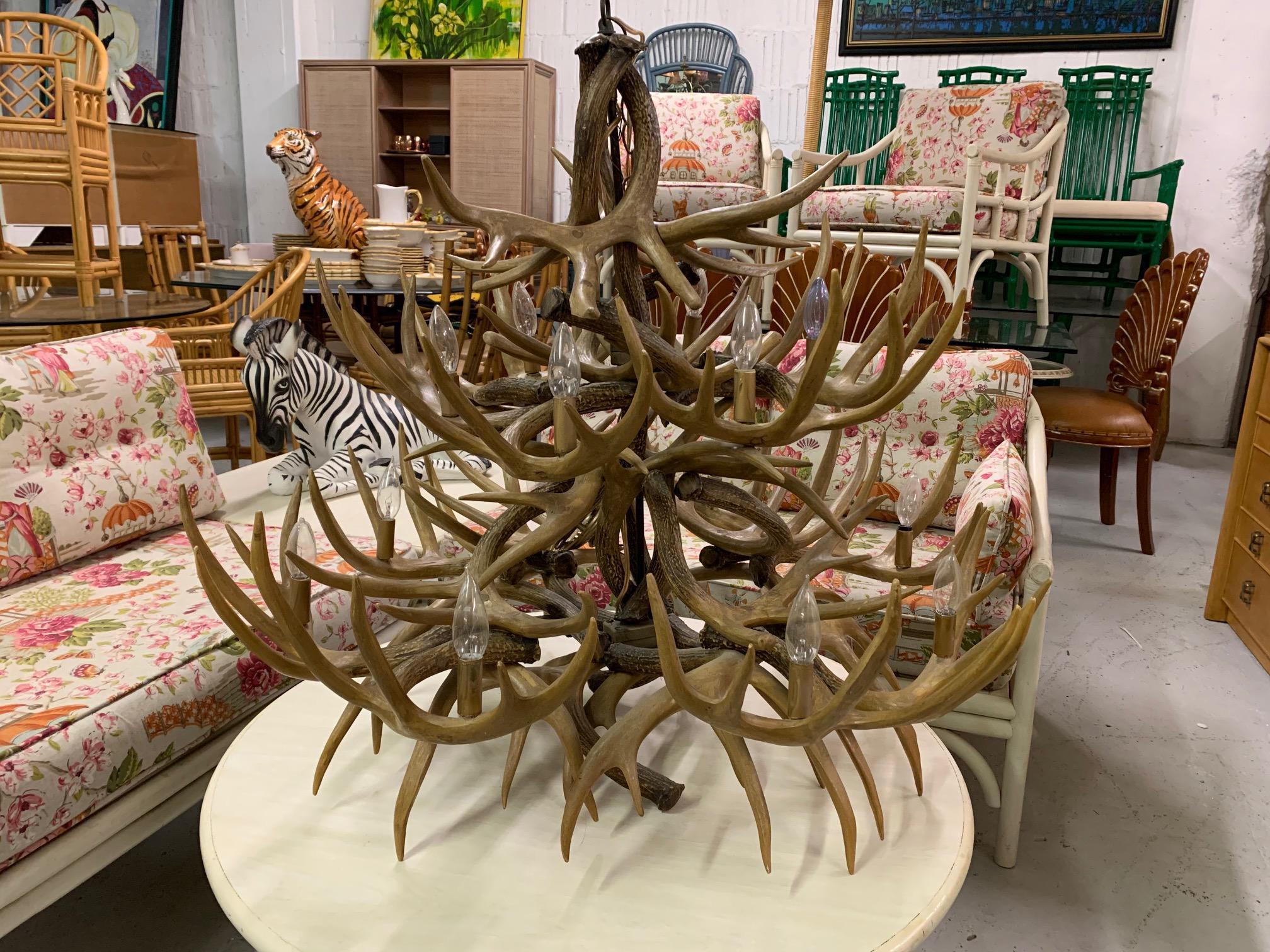 Large antler chandelier features 14 lights and dozens of stag antlers. Hand made in the mid-20th century. Very good vintage condition with no flaws to speak of, and a warm natural patina.
 