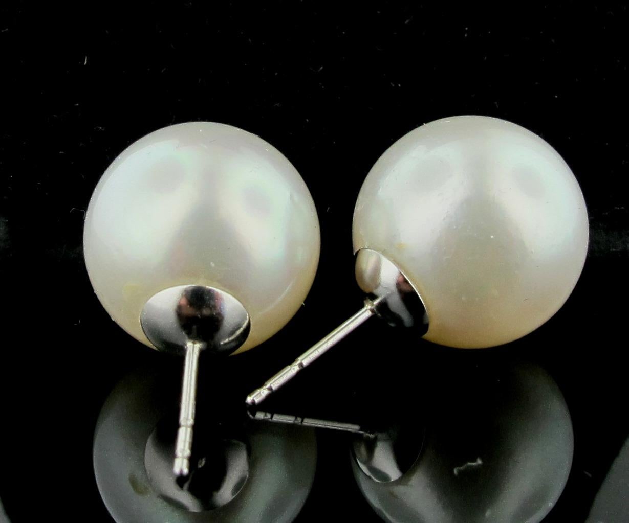 A pair of 14 millimeter South Sea Pearls set in 14 karat white gold stud mounting.
High luster, lightly blemished. Excellent match. 