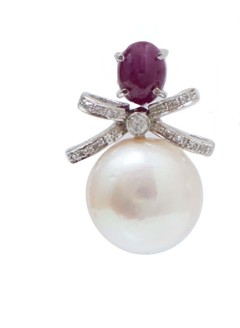 Fantastic  earrings in platinum structure mounted with a ruby in the upper part; in the middle, a shape bow structure studded with diamonds and, as pendant, pearl.
These earrings were totally handmade by Italian master goldsmiths and they are in