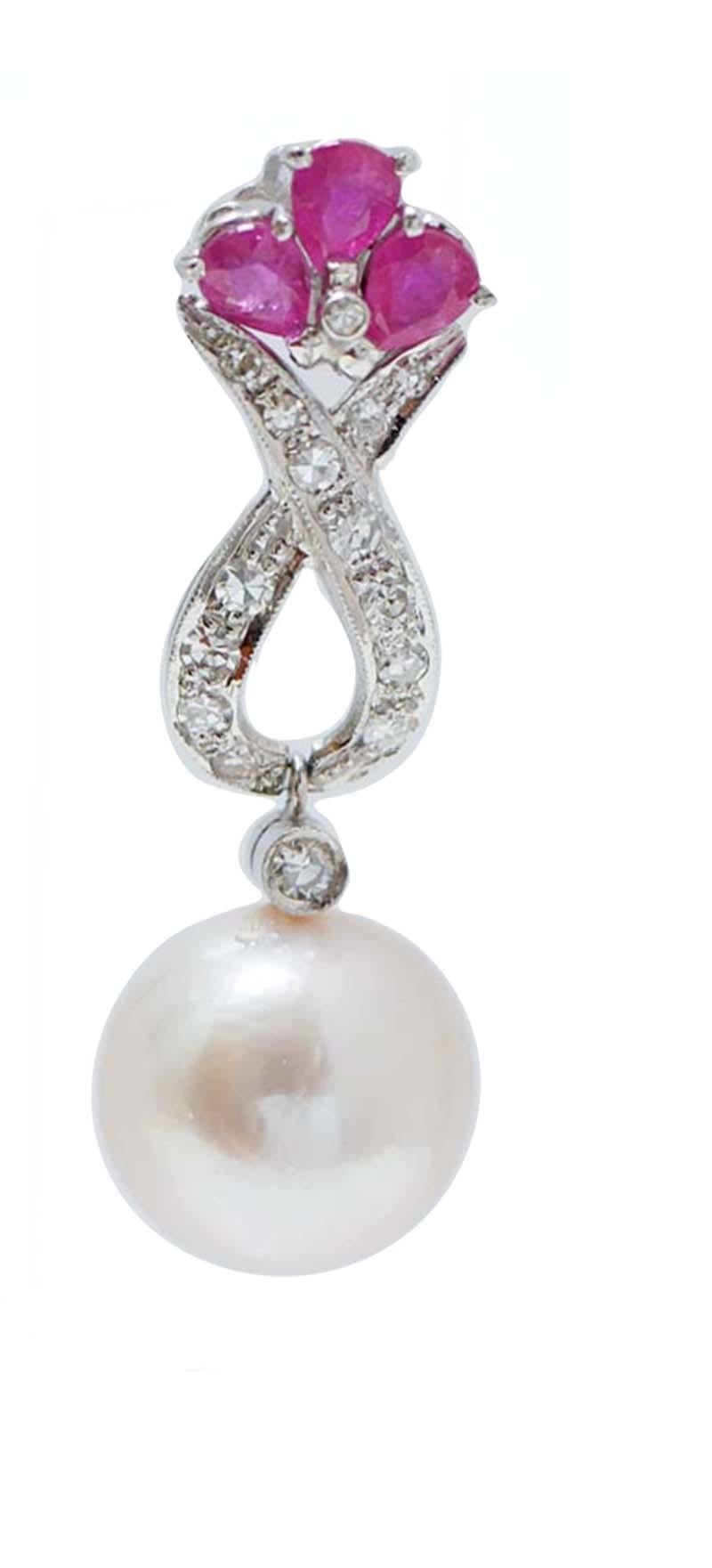 Amazing earrings in platinum structure mounted with three rubies in the upper part; in the middle, diamonds and, a pendant, a pearl.
These earrings were totally handmade by Italian master goldsmiths and they are in perfect conditions.
Diamonds 1.03