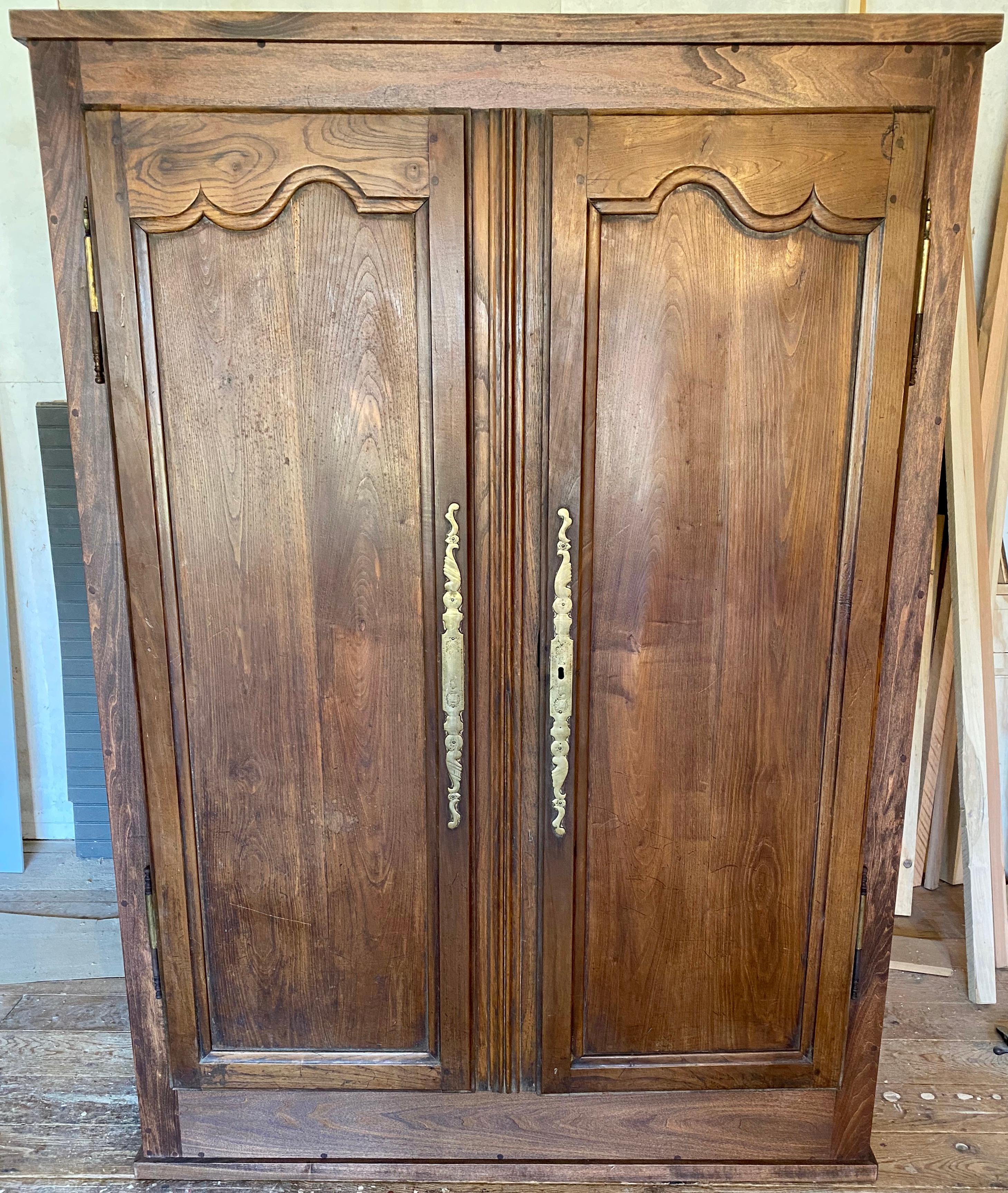 Very shallow depth two door armoire that will fit into a small room or space for extra storage or serve as entertainment cabinet for large screen TV, video and audio equipment. The cabinet is newly constructed incorporating a pair of antique French
