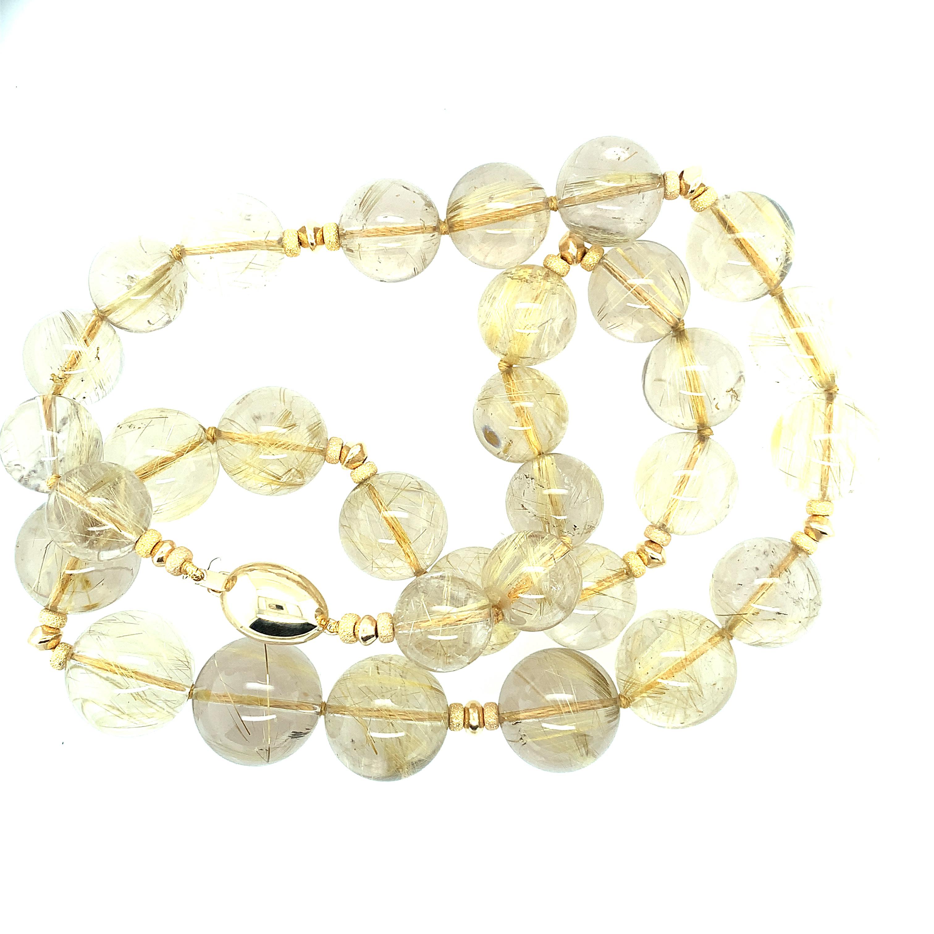 This strand of gigantic rutilated quartz beads is a stunning wonder of nature!  Each quartz bead possesses its own world of golden rutile needles that look like golden pieces of straw that catch light beautifully. The strand contains beads that