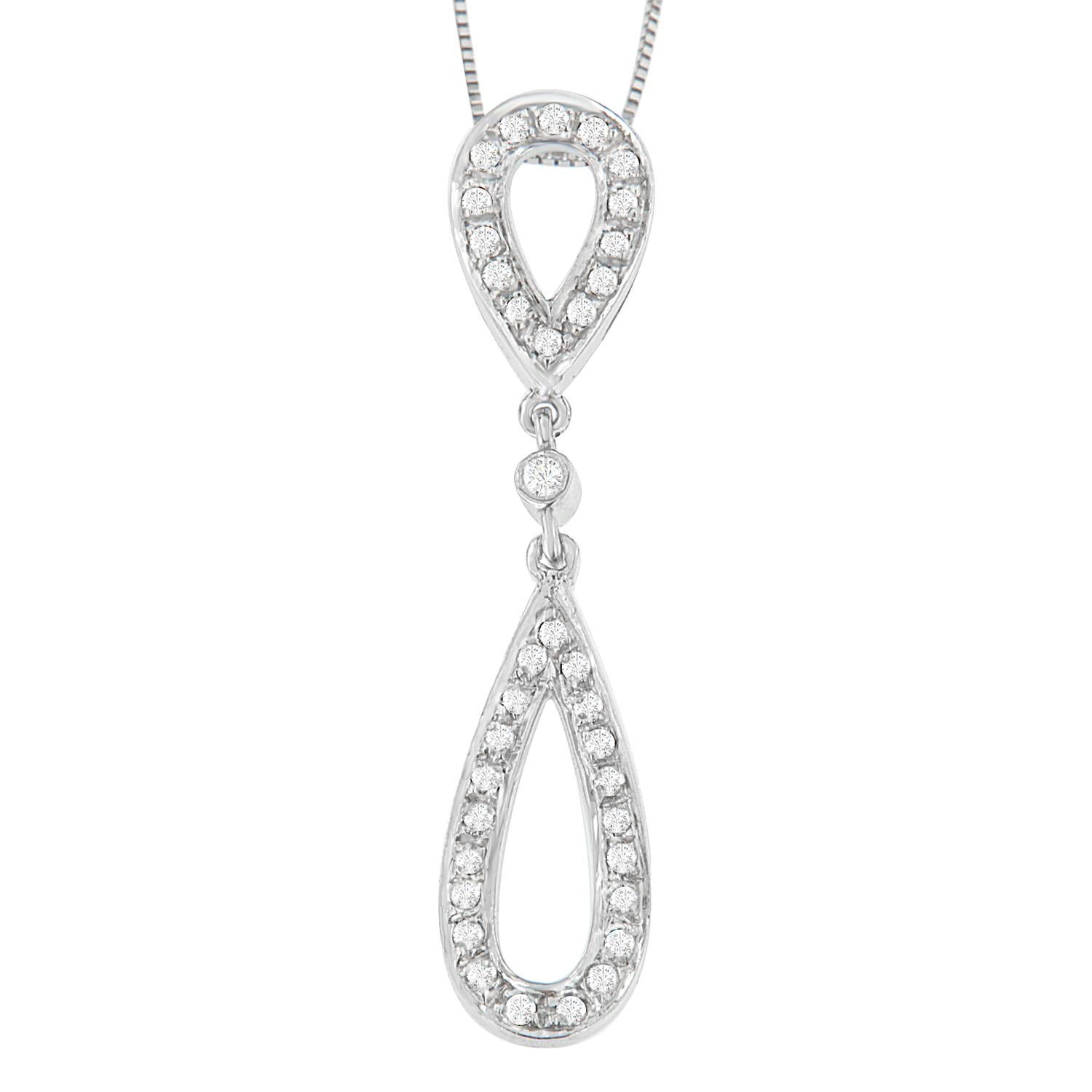 The beauty of this pendant is in the details. A modern 14 karat white gold setting connects two tear drop shapes at top and bottom, which are covered in glittering round cut diamonds for an extra dose of drama. This beautiful necklace includes 18”