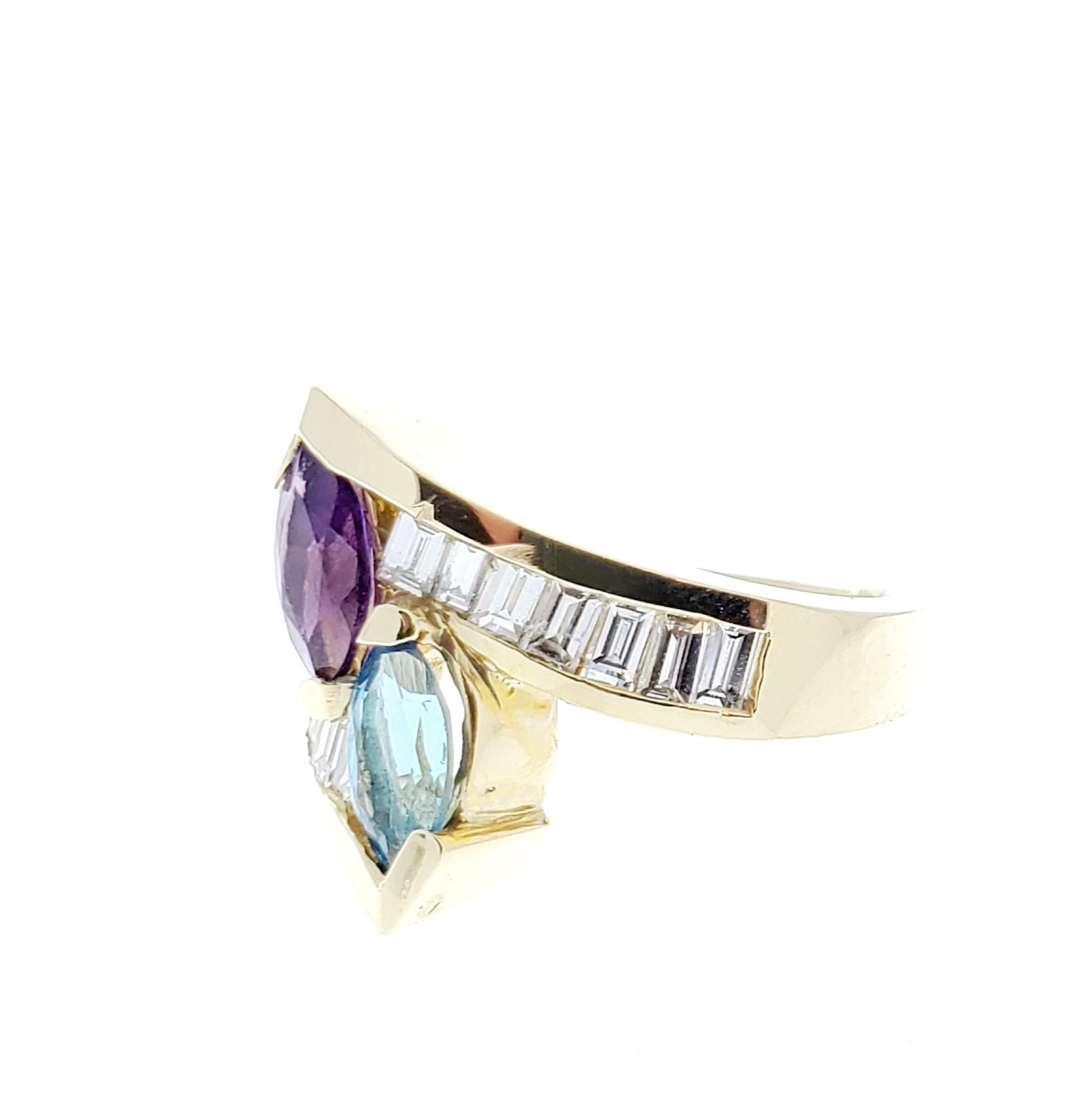 This gorgeous 14 karat yellow gold gemstone cocktail ring features one marquise cut blue topaz and one marquise cut amethyst prong set in the center of this sweeping bypass design, totaling 1.40 carats, and displaying incredible vibrancy. A total of