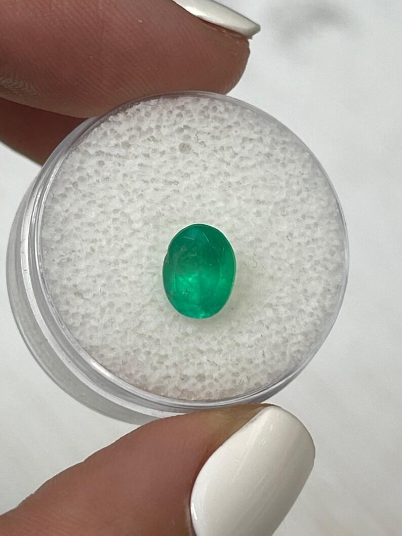 Stone: Emerald
Weight: 1.40-carats
Shape: Oval Cut
Clarity: Semi-Transparent
Luster: Very Good/Good
Color: Medium Yellowish Green
Measurements: 7.90mm x 6.38mm x 4.81mm
Geographic Origin: Colombia
Treatment: Natural, Oiling

Comments: Due to their