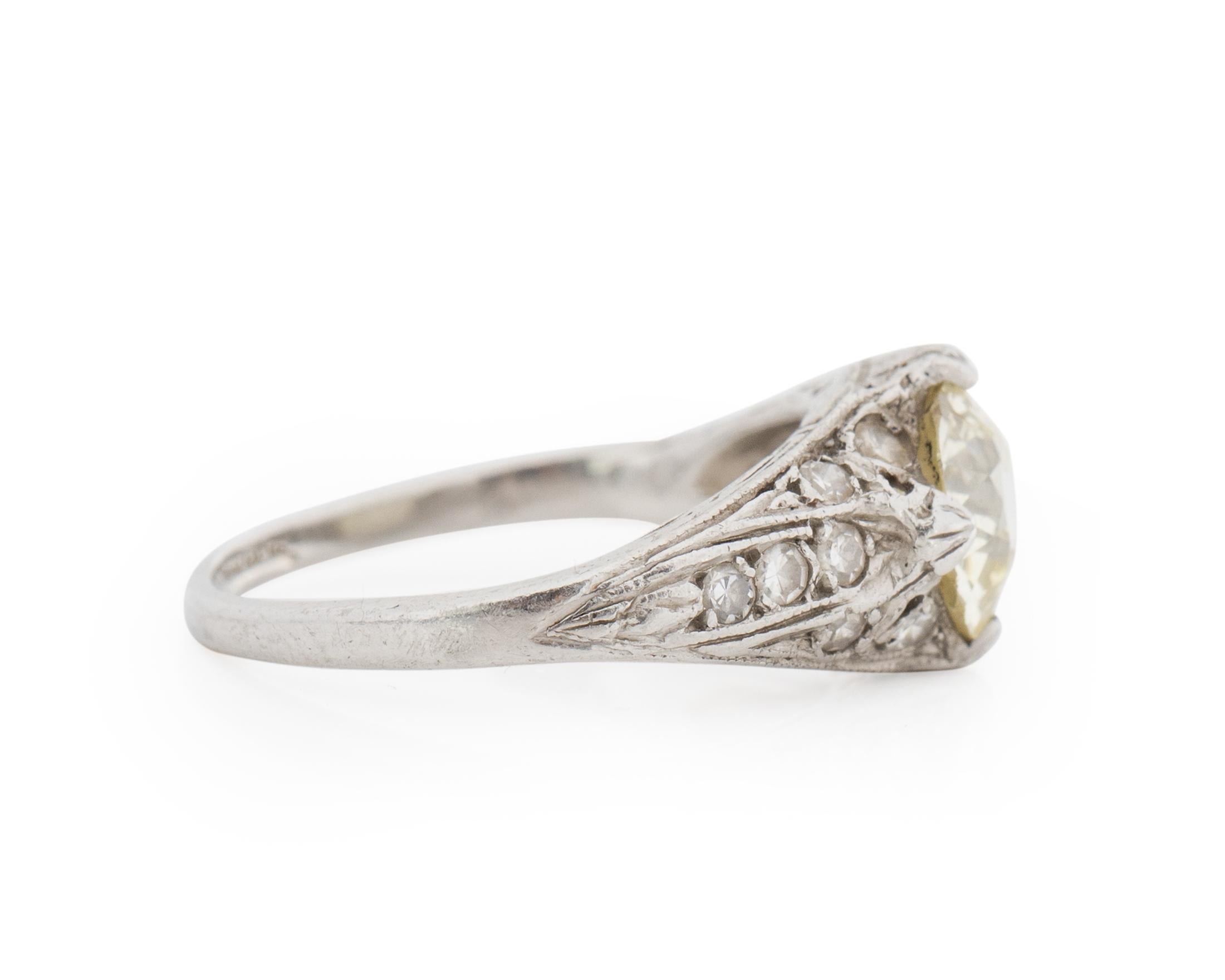 Item Details: 
Ring Size: 6
Metal Type: Platinum [Hallmarked, and Tested]
Weight: 3.5 grams

Center Diamond Details:
Weight: 1.40 Carat
Cut: Old European Brilliant
Color: Q-R (Light Yellow)
Clarity: SI2
Measurements: 7.4mm

Side Diamond