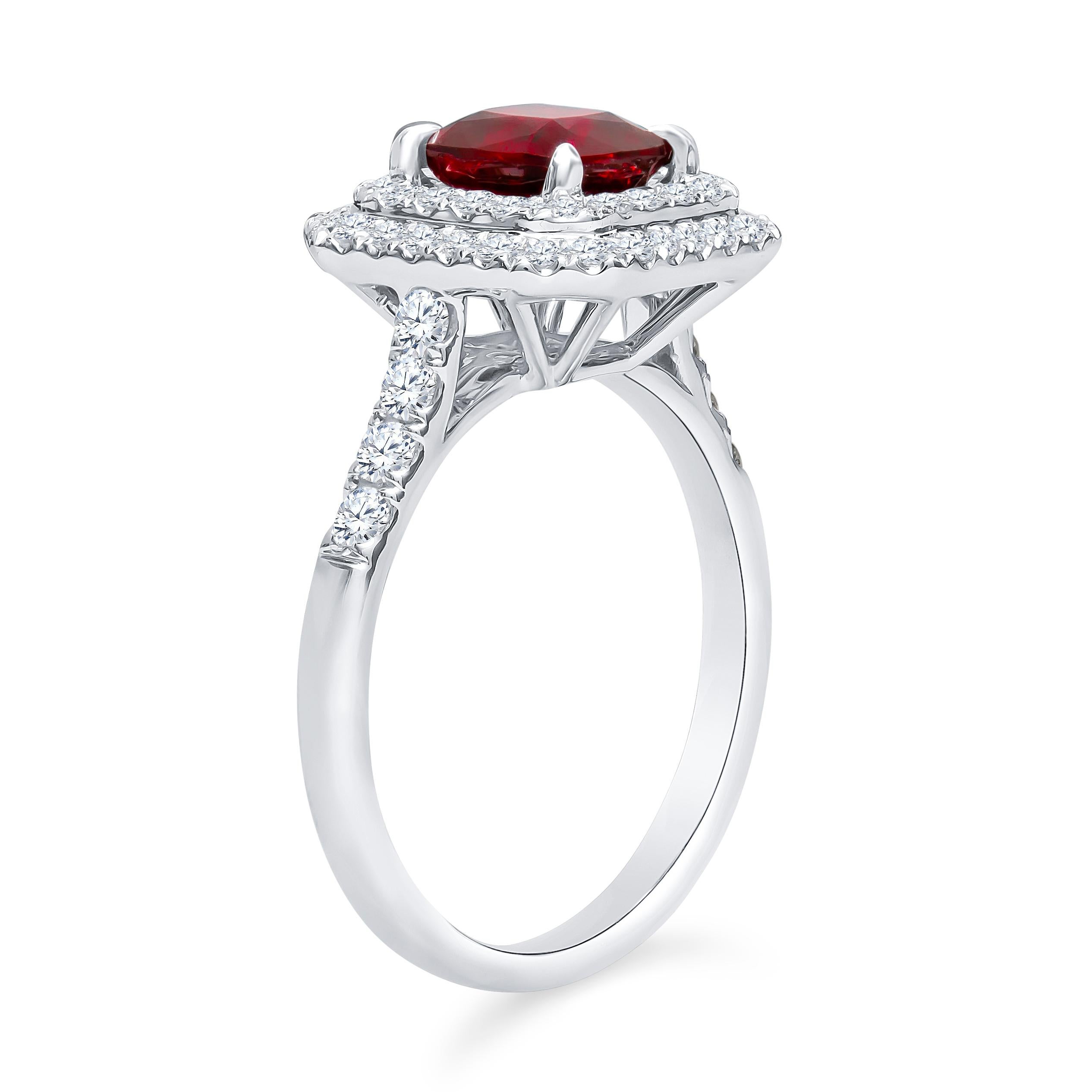 Beautiful, vivid red 1.40ct natural cushion cut ruby set in a custom 18K white gold double-halo ring with 0.63ct total in fine diamonds. The ruby is accompanied by a lab report from IGI (#GT13158608) and is of natural origin with standard heat