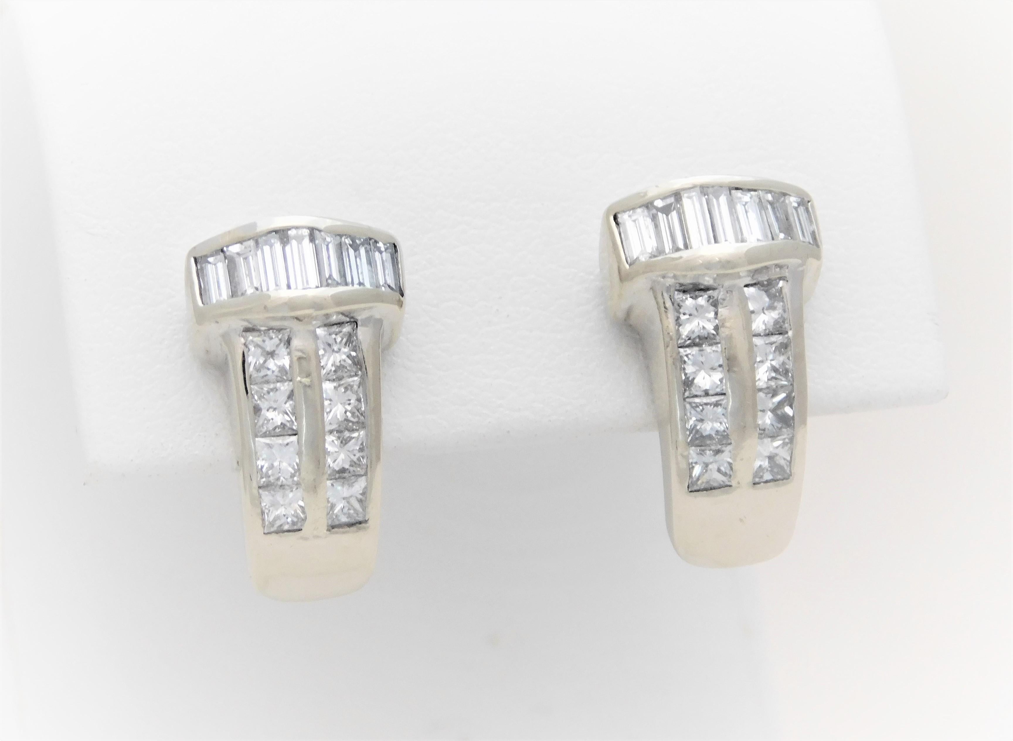   These dazzling drop-style earrings have been hand crafted in solid 14k white gold.  They, as a set, are exquisitely set with a total of 14 natural baguette cut and 16 natural princess cut diamonds approximating 1.40ct in total weight.  Every one