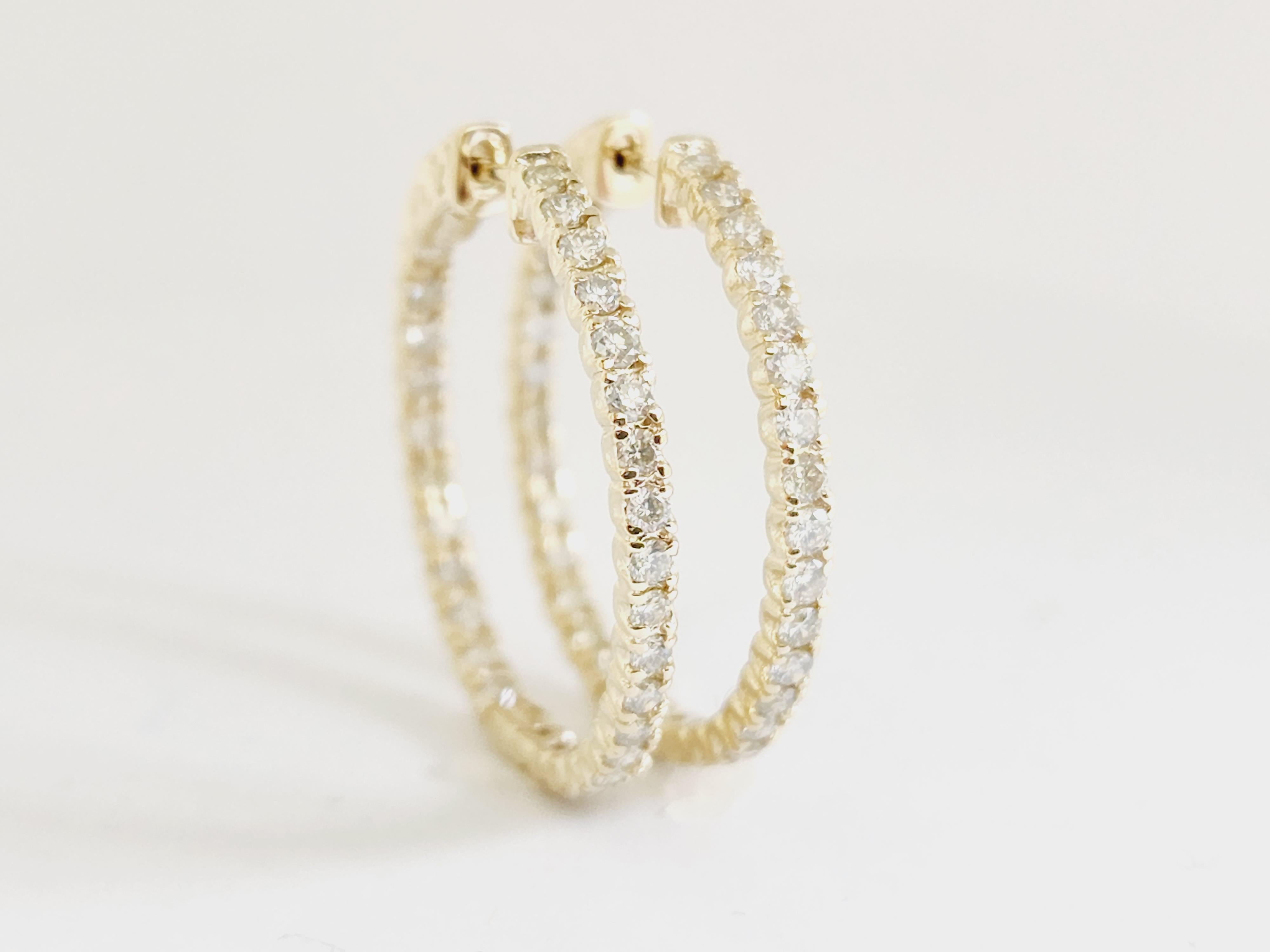Beautiful pair of diamond inside out hoop earrings in 14k yellow gold. Secures with snap closure for wear. Elegance for every moment.

Average Color I, Clarity SI, 
Measures 1 inch diameter. 