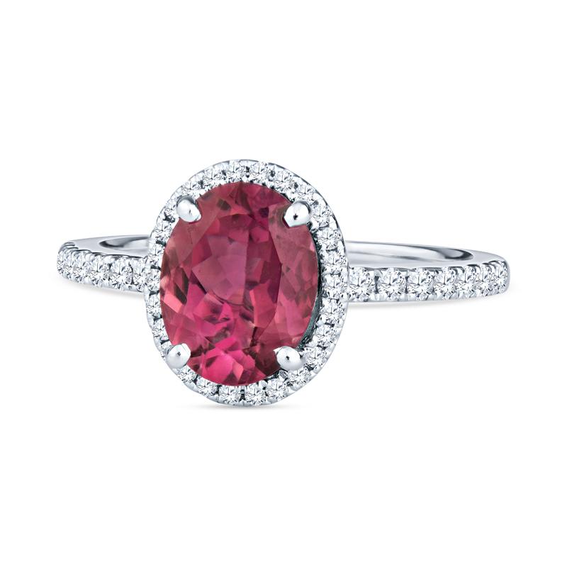 This beautiful ring features a 1.40 carat natural oval pink tourmaline accented by 0.55 carat total weight in round diamonds set in 18 karat white gold. It is a size 5.75 but can be resized upon request. 
Measurements: Tourmaline measures