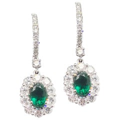 1.40 Carat Oval Cut Emerald and 1.88 Carat Diamond Earrings Set in 18 Karat Gold