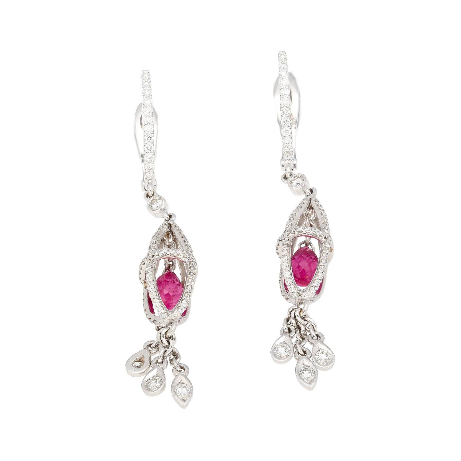 These captivating earrings showcase a 1.40ct total of sparkling checkerboard faceted pear-cut pink sapphire dangling in the center of a cage motif drop earring. Crafted in lustrous 18k white gold and secured with comfortable lever back closure.