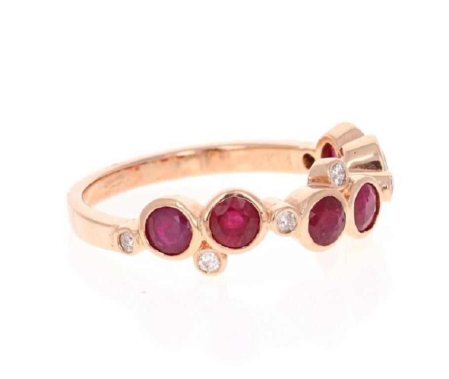 This unique band has 6 floating Round Cut Rubies that weigh 1.30 Carats and 7 Round Cut Diamonds that weigh 0.10 Carats. 

The ring is casted in 14K Rose Gold and weighs approximately 2.6 grams. 

It is a size 7 and can be re-sized at no additional