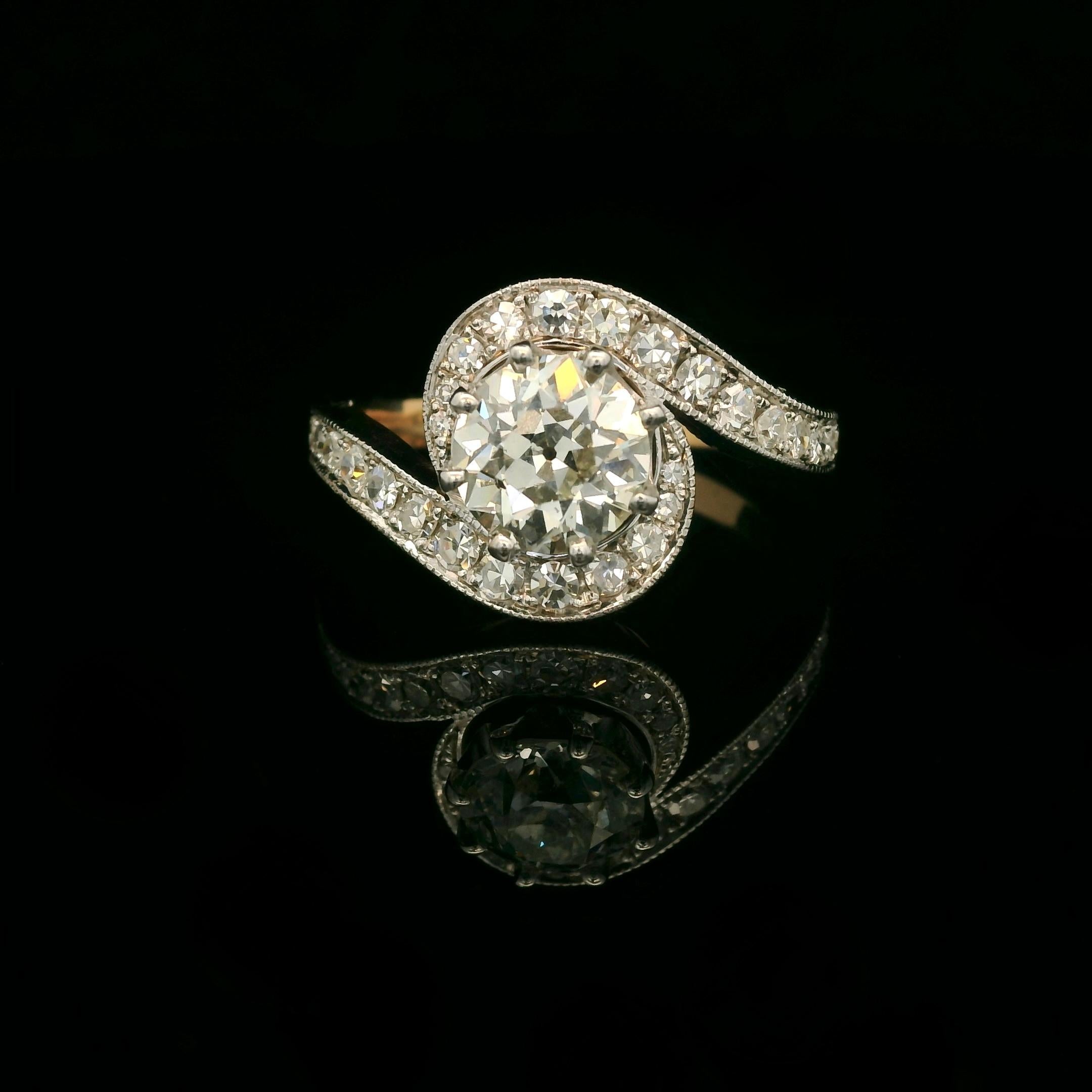 Bicolore white and yellow gold 18 Karat tourbillon ring. 

1910's inspired tourbillon ring set with a center old European cut diamond of approximately 1.40 Carats ( H color - Si2 purity) and 28 8/8 cut diamonds for a total of approximately 0.55