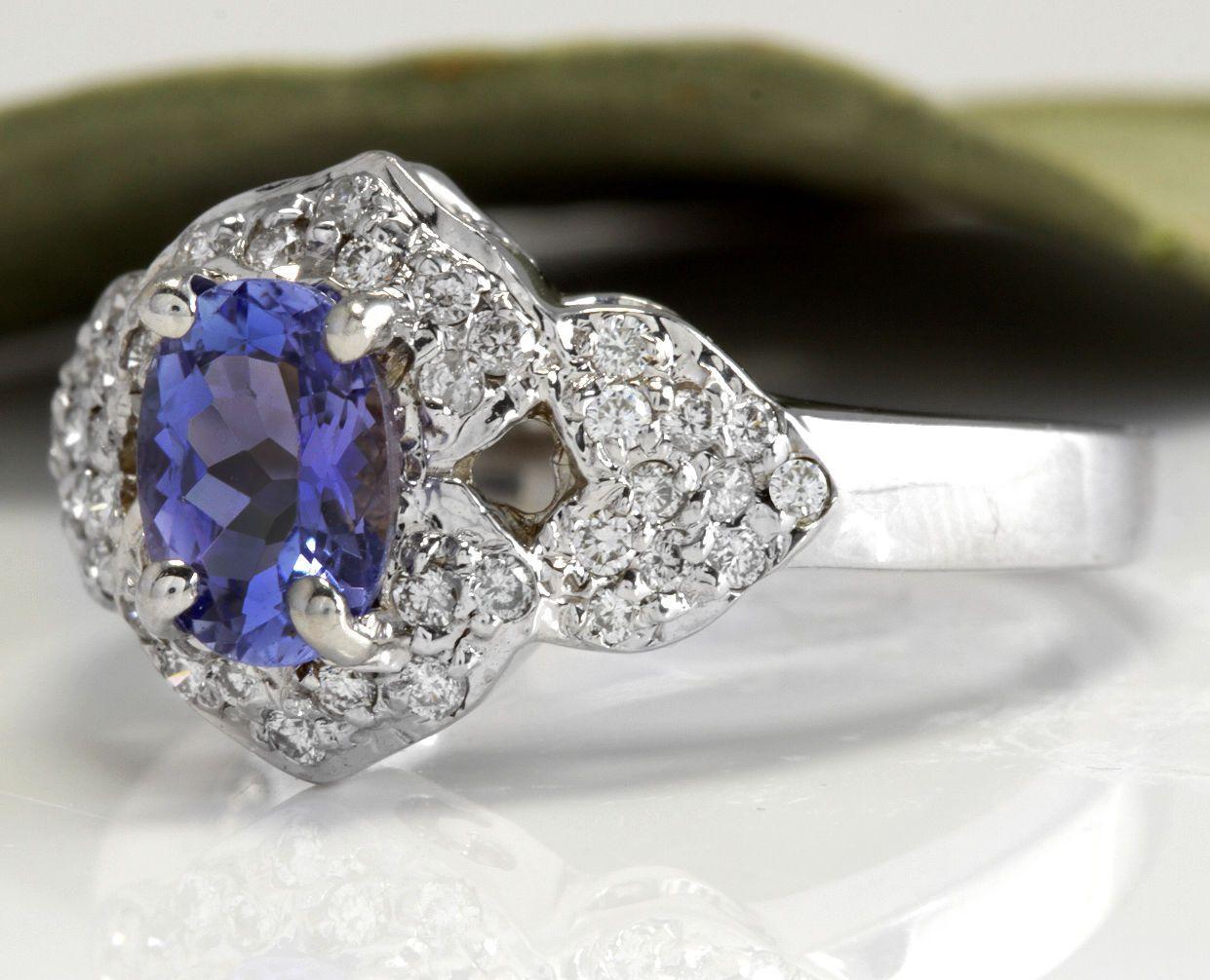 1.40 Carats Natural Very Nice Looking Tanzanite and Diamond 14K Solid White Gold Ring

Total Natural Oval Cut Tanzanite Weight is: 1.00 Carats

Natural Round Diamonds Weight: .40 Carats (color F-G / Clarity VS2-SI1)

Ring size: 6 (we offer free