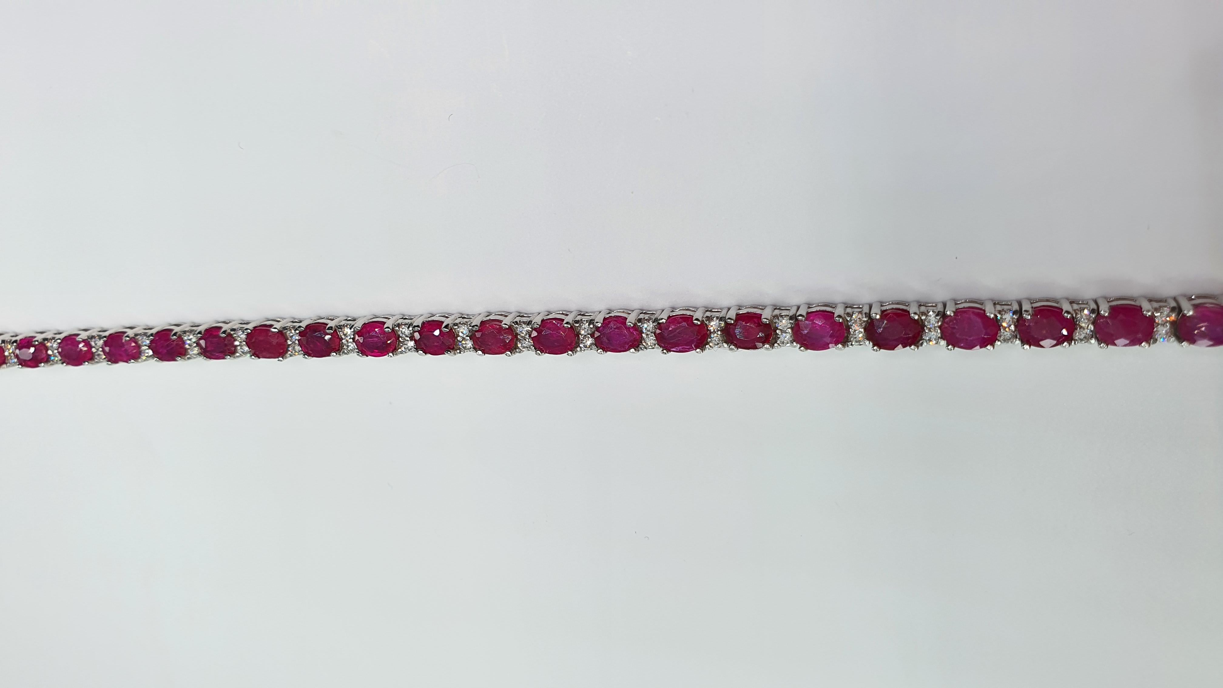 14 Carat Ruby Diamond 18K White Gold Tennis Bracelet

Stamped: 18K
Total Bracelet Weight: 12 Grams
Bracelet Length: 7.5 Inches
Ruby Weight: 13.00 Carat (5.00x4.00 Millimeter)
Diamond Weight: 1.00 Carat (F-G Color, VS2-SI1 Clarity
Face Measures: 4.00