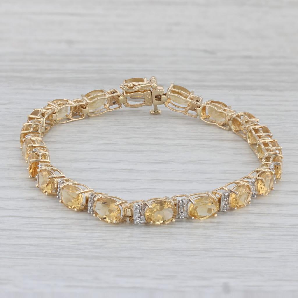 Gemstone Information:
- Natural Citrine -
Total Carats - 13.90ctw
Cut - Oval Brilliant
Color - Orange
Treatment - Heated

- Natural Diamonds -
Total Carats - 0.12ctw
Cut - Single
Color - I - K
Clarity - SI2 - I3

Metal: 14k Yellow Gold 
Weight: 10.4