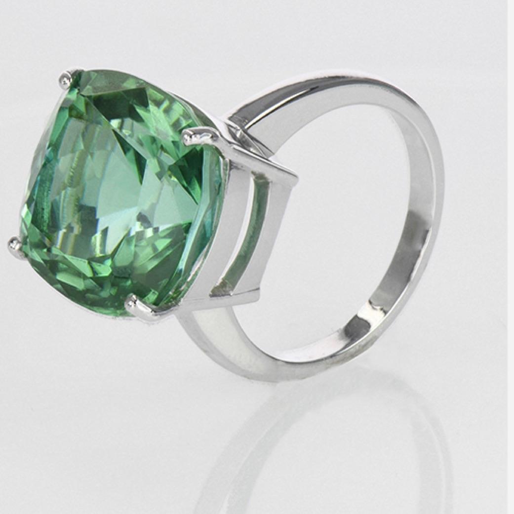Mint Green Solitaire 
Creator: Carson Gray Jewels	
Ring Size: 6.5
Metal: 18KT White Gold
Stone: Mint Green Tourmaline
Stone Cut: Cushion; Modified Brilliant
Weight: 14.06 carats
Style: Statement Ring
Place of Origin: Congo
Period: Modern
Date of