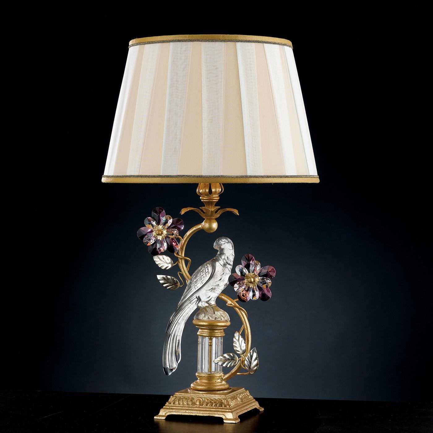 Inspired by centuries of style, this table lamp features an elegant bird in bold silver leaf. On a gold leaf base, the bird is framed with crystals and amethysts in floral compositions, creating a stand out style for traditional living rooms and