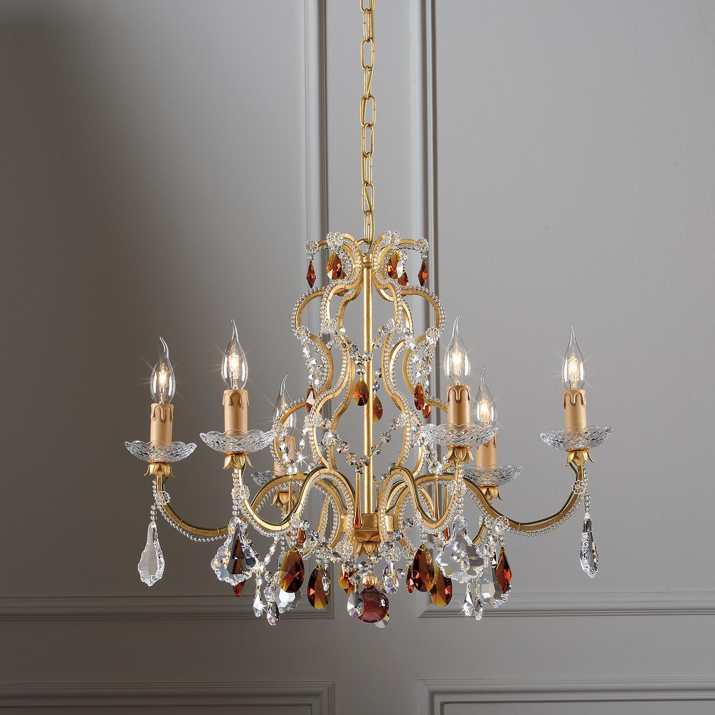 A modern chandelier with traditional inspiration, dripping with transparent and amber crystals. Made in metal with a sumptuous gold leaf finish, the chandelier is inspired by centuries of tradition, with a pared down modern feel, making it the