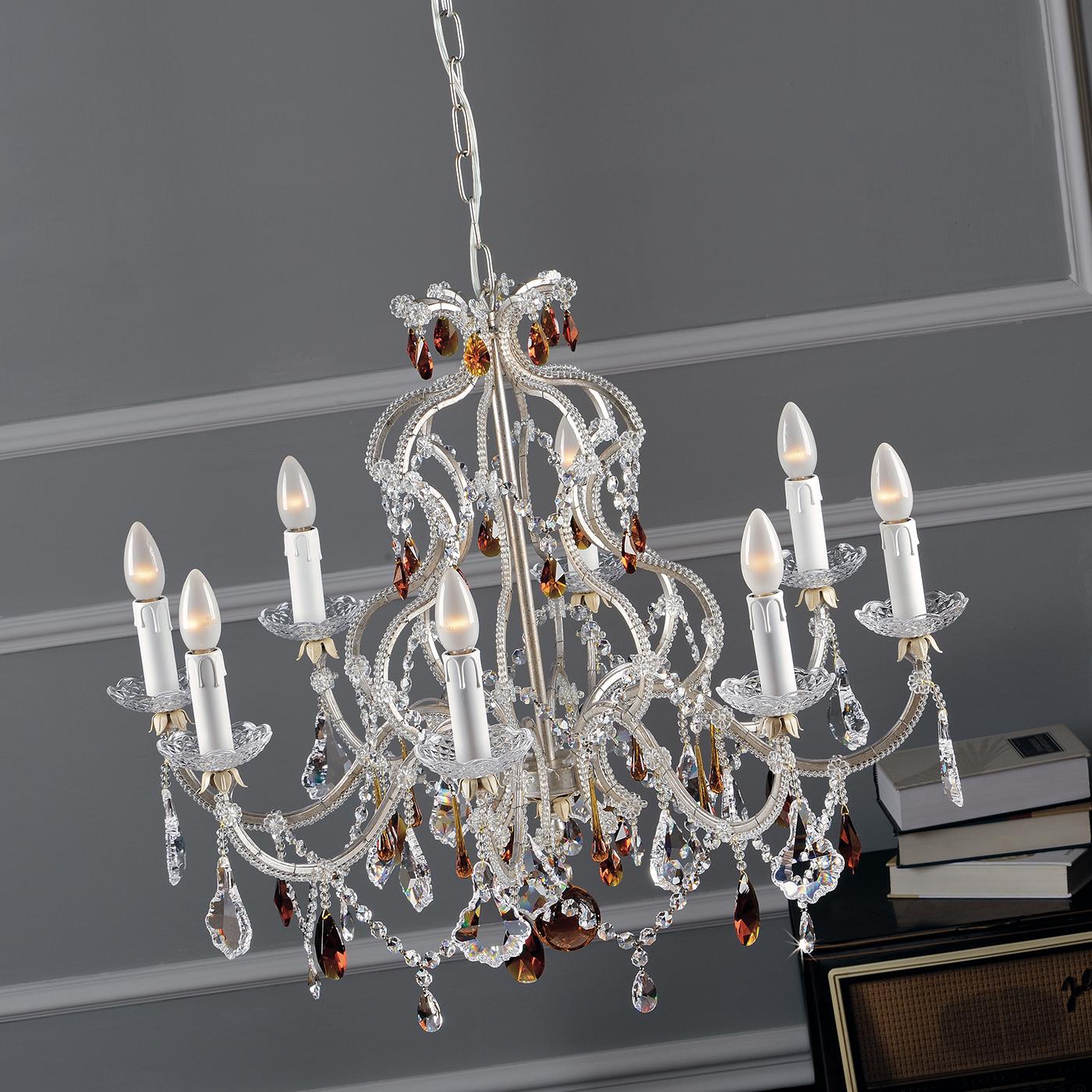 Assembled entirely by hand, this unique chandelier blends traditional and modern accents to perfection. With eight gently curving arms, the silver leaf chandelier is accented with glass pearls and crystals, both transparent and amber-colored.