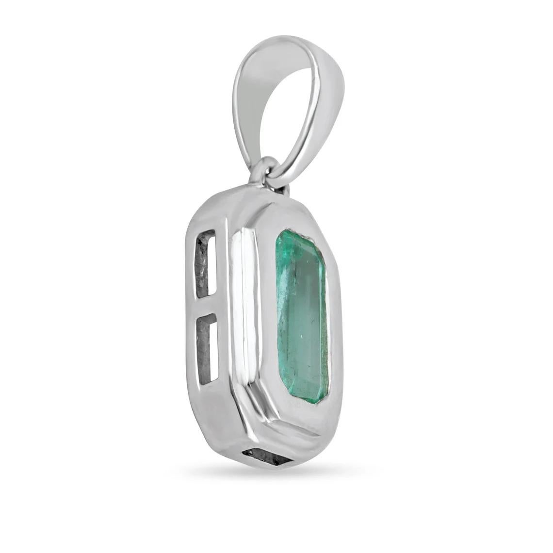 A stylish and sleek, unisex Colombian emerald pendant. This special piece showcases a remarkable 1.40-carat, elongated emerald cut emerald. The gemstone displays a beautiful medium-light spring green color, with excellent luster and very good eye
