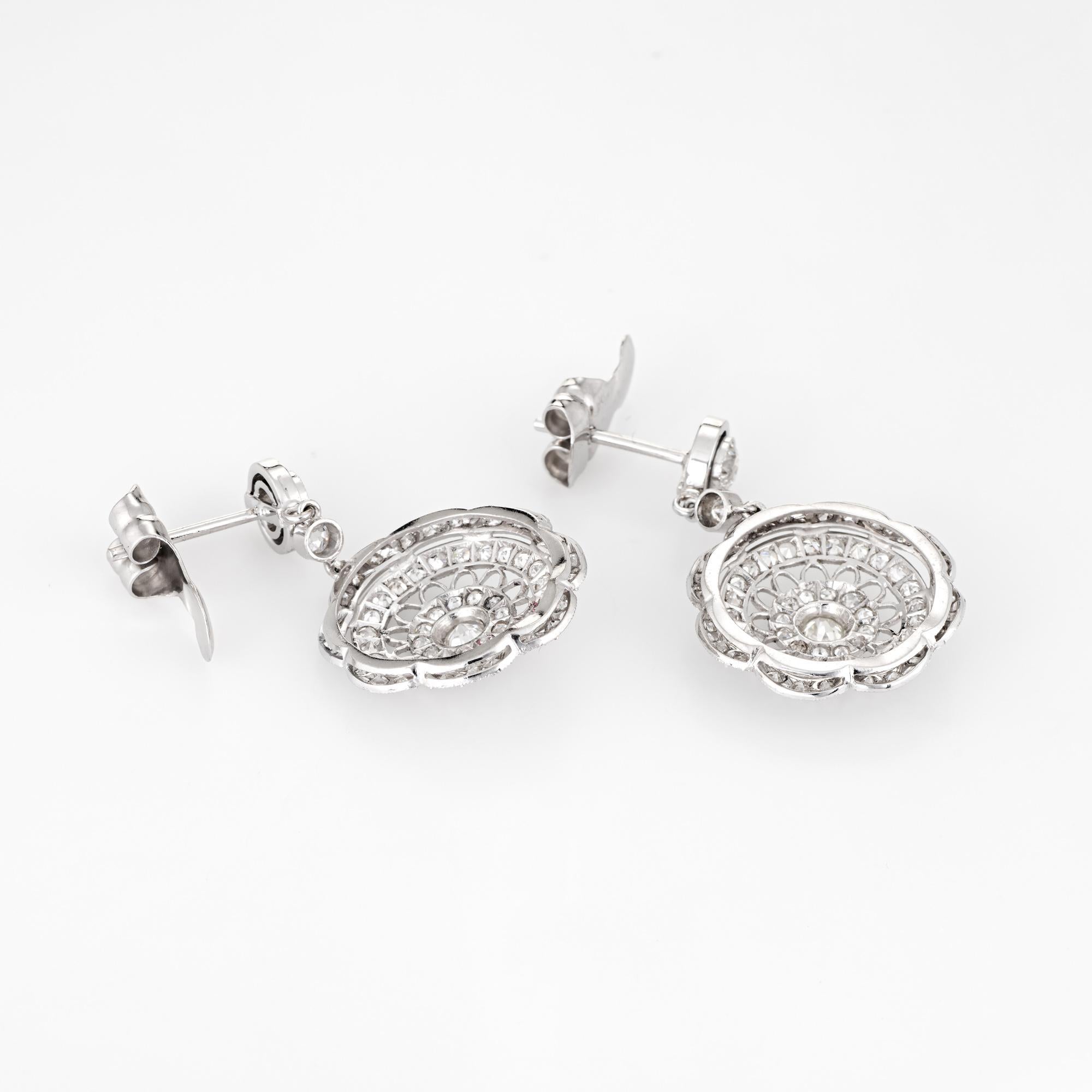 Elegant pair of estate diamond earrings crafted in 18k white gold. 

Single & old mine cut diamonds total an estimated 1.40 carats (estimated at I-J color and VS2-SI2 clarity).  

The diamonds are set into round openwork filigree mounts, overlaid