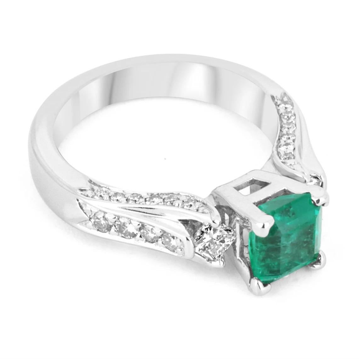 Featured here is a classic emerald and diamond engagement ring. Expertly handcrafted in gleaming 14K white gold; this ring features one fine quality emerald in a four-prong setting. The center is an extraordinary gemstone and has profound color