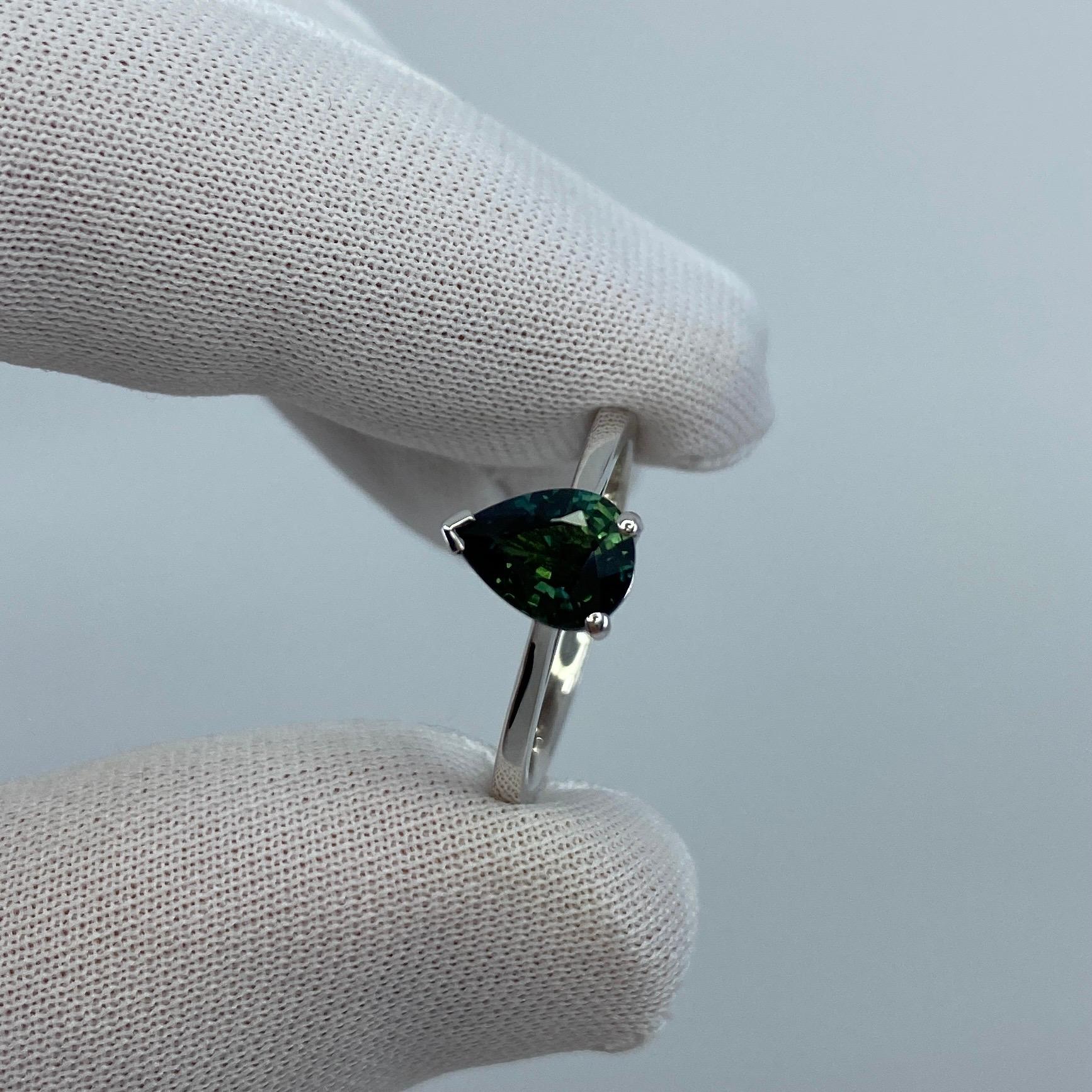 Natural Deep Blueish Green Sapphire 18k White Gold Solitaire Ring.

1.41 Carat sapphire with a stunning deep blue green colour and excellent clarity. Very clean stone with only some small natural inclusions visible when looking closely.
The sapphire