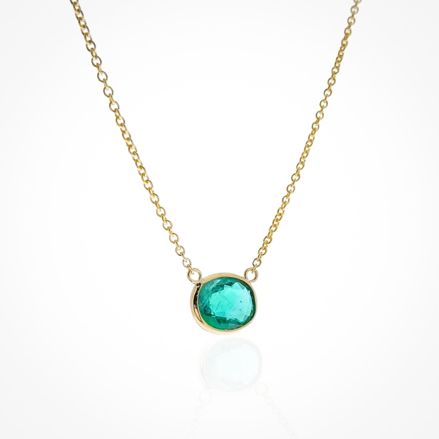 This necklace features an oval-cut green emerald with a weight of 1.41 carats, set in 14k yellow gold (YG). Emeralds are known for their rich green color, and the oval cut is a classic and timeless choice for gemstones, offering an elegant and