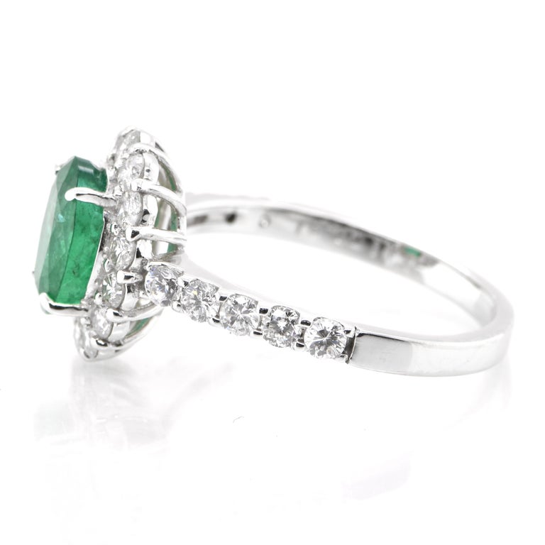 Oval Cut 1.41 Carat Natural Emerald and Diamond Halo Ring Set in Platinum For Sale