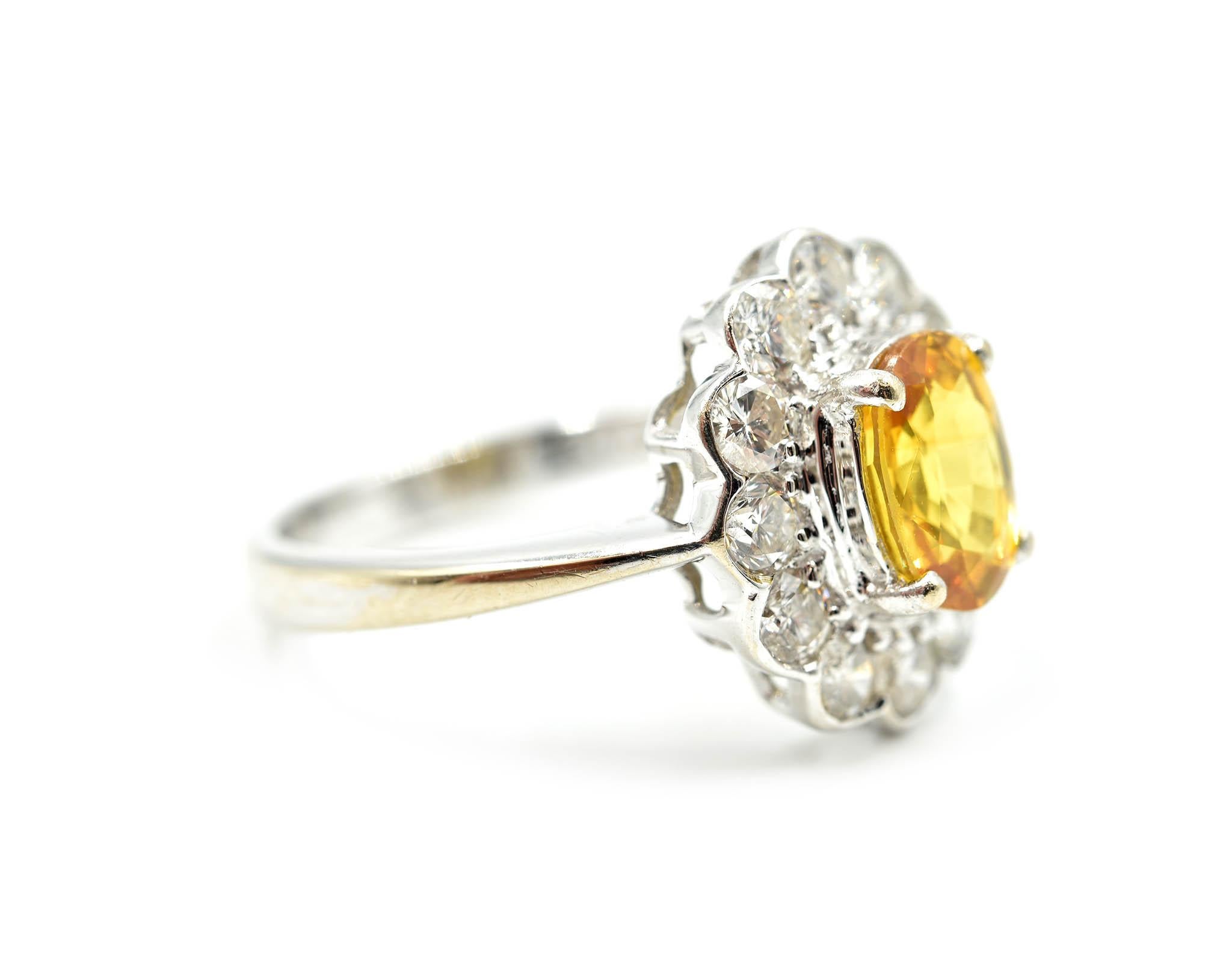 Designer: custom design
Material: 18k white gold
Yellow Sapphire: one oval cut 1.41 carat yellow sapphire
Diamond: twelve round brilliant cut diamonds = 1.00 carat weight
Color: H
Clarity: VS2-SI1
Dimensions: ring top measures 1/2-inch long and