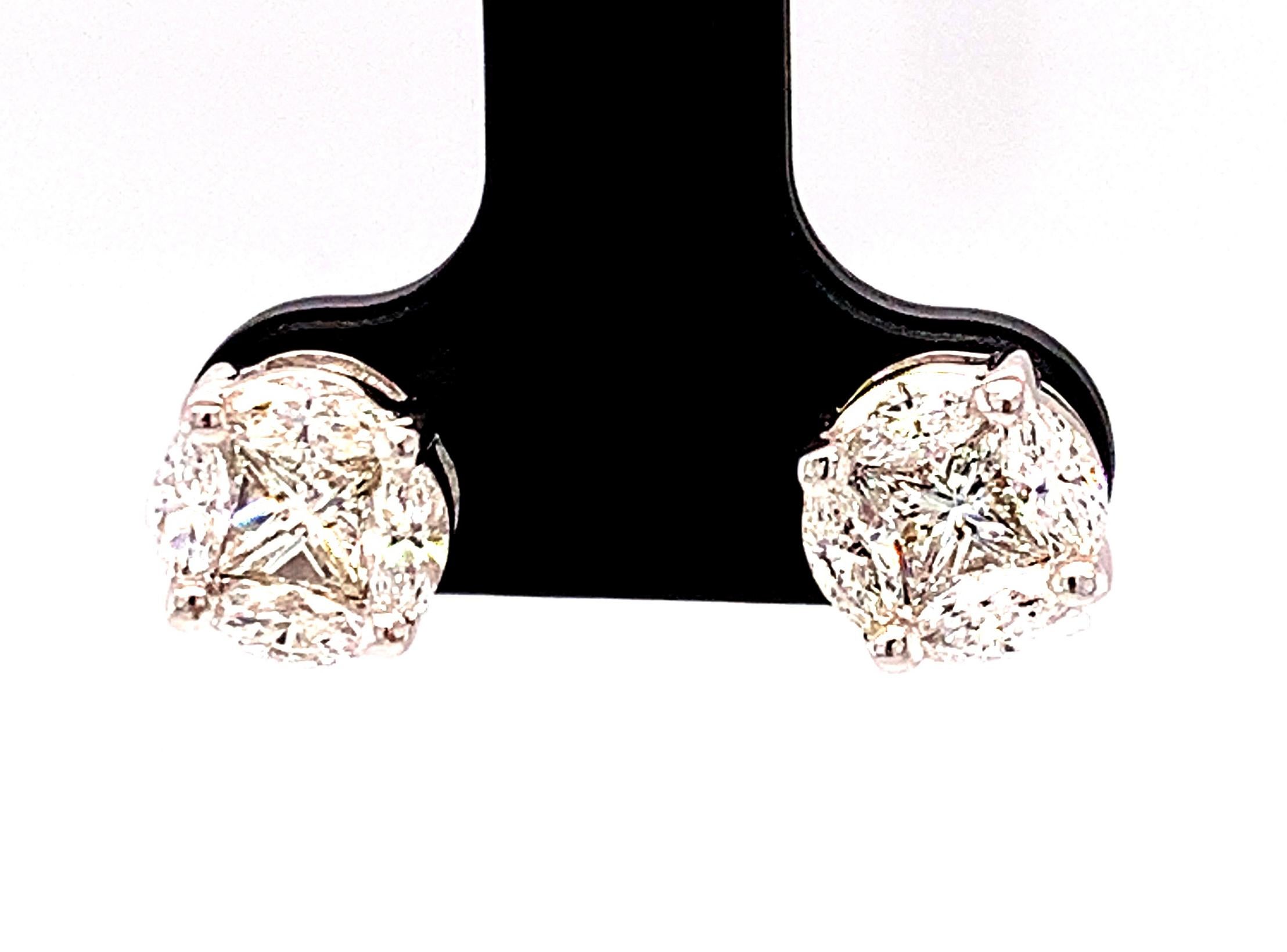 These diamond cluster earrings give the illusion of large, single diamond studs! In fact, each earring is comprised of a single princess cut diamond framed by 4 marquise cut diamonds. While the total carat weight of these diamonds is 1.41 carats,