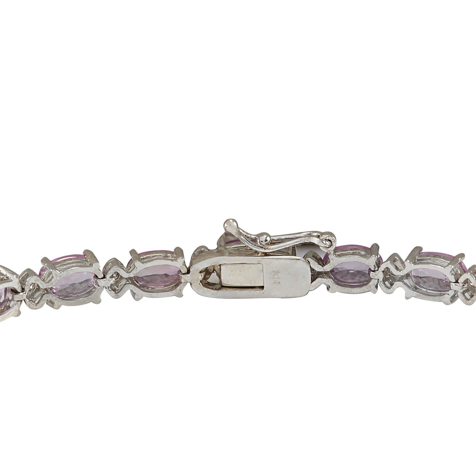 Stamped: 14K White Gold
Total Bracelet Weight: 9.0 Grams
Bracelet Length: 7 Inches
Bracelet Width: 4.00 mm
Total Natural Sapphire Weight is 13.50 Carat
Color: Pink
Total Natural Diamond Weight is 0.60 Carat
Color: F-G, Clarity: VS2-SI1
Face