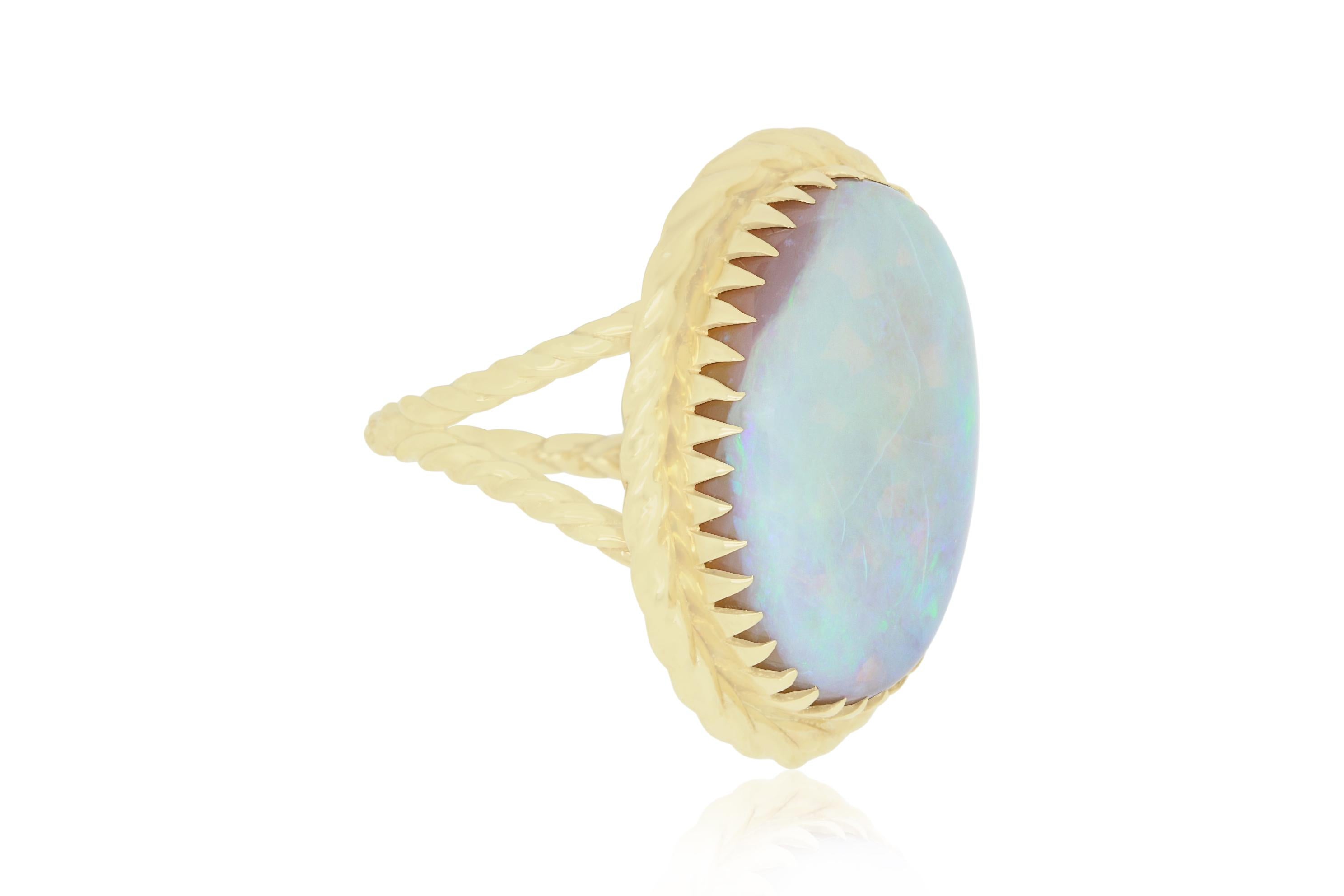 This stunning yet simple 14.10 Carat Oval shaped Opal is braided in 14K Yellow gold. A summer favorite! 

Material: 14k Yellow Gold
Gemstone: 1 Oval Opal at 14.10 Carats.
Ring Size: 6.5 (Can be sized)

Fine one-of-a kind craftsmanship meets
