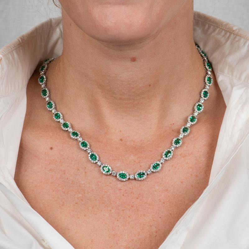 This one of a kind necklace features 14.12 carat total weight in oval cut natural emeralds accented by 8.66 carat total weight in round diamonds. It is set in 18 karat white gold and measures 17.5