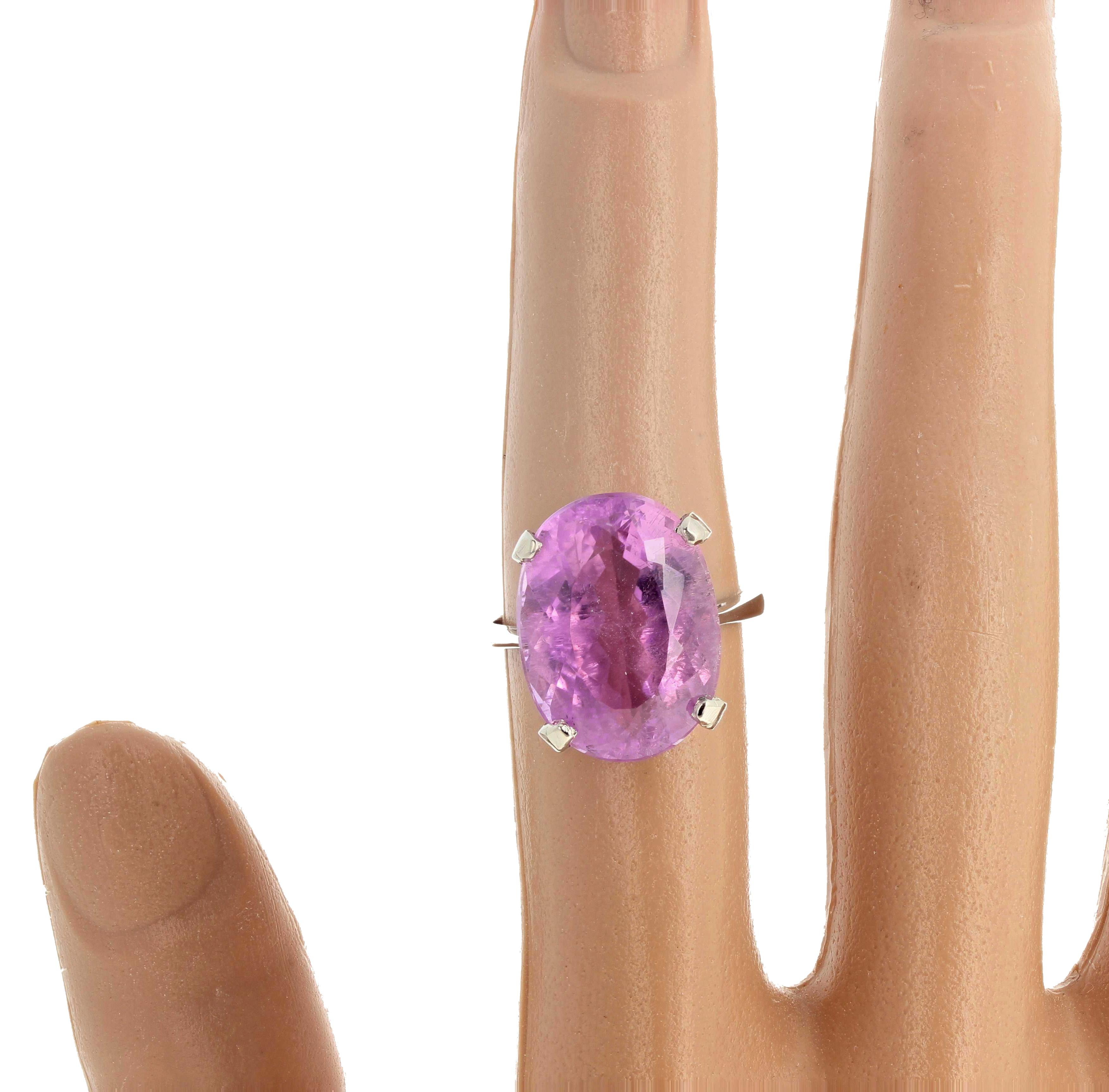 Deep Intense Pink sparkling natural 14.16Kt  Brasilian Kunzite  (17.1mm x 12.8 mm) set in a lovely sterling silver ring size 7 sizable.  The quality of this lovely Kunzite can be seen by looking at the photograph of the gemstone through the back of